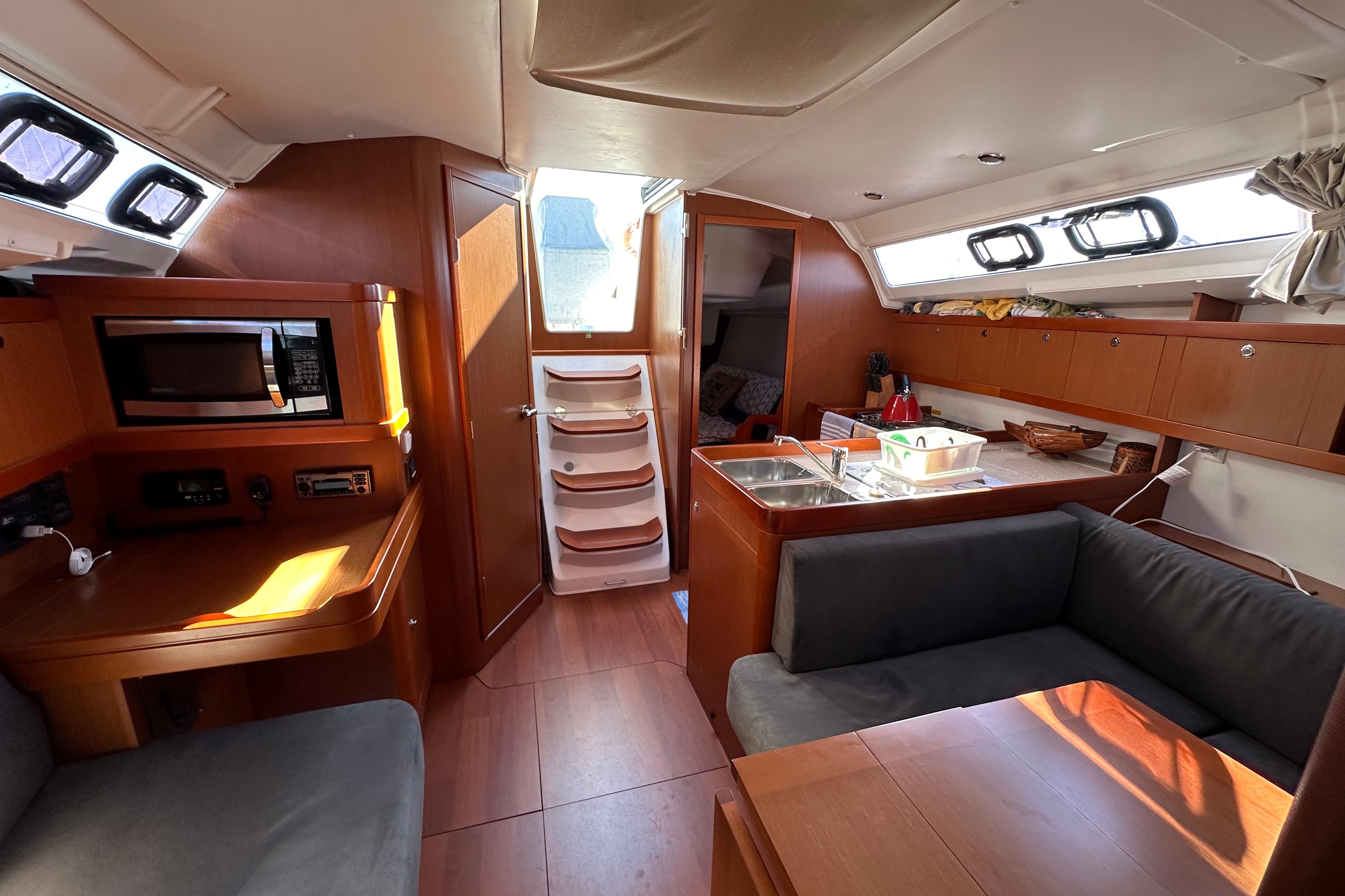 Interior of 2015 Beneteau Oceanis 37 sailboat with modern kitchen and seating area.