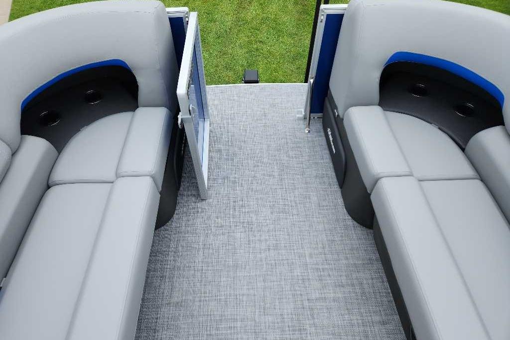 2026 Sun Tracker Party Barge 20 DLX interior with gray seating and open gate.