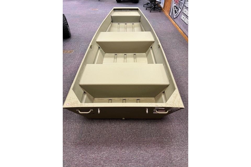 2025 Tracker Grizzly 12 Jon boat, olive green, displayed indoors on carpet.