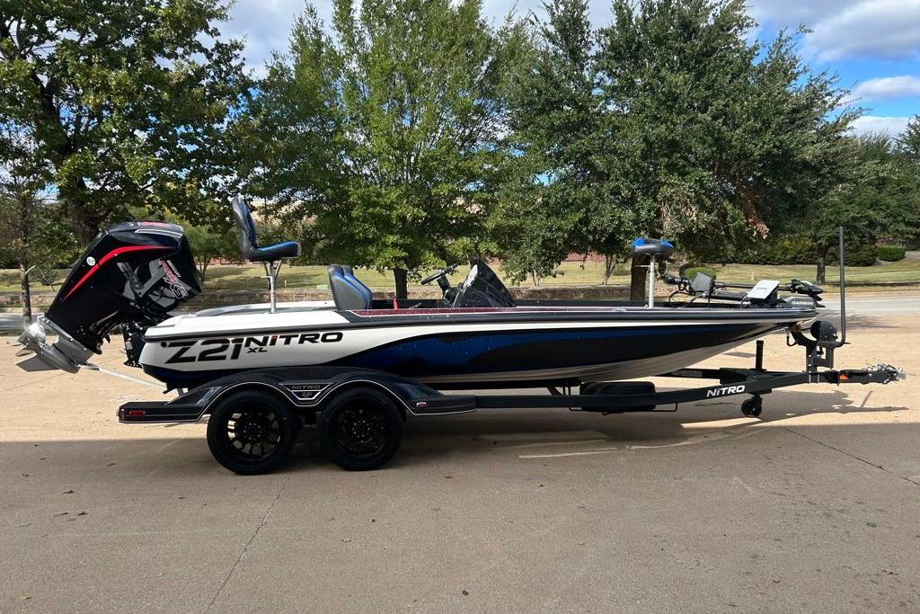 2026 Nitro Z21 XL Pro boat on trailer, parked outdoors with trees in background.