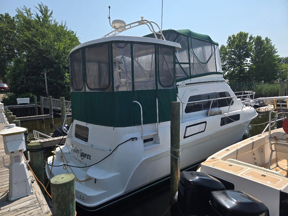 A 1994 Mainship 37 MY docked, surrounded by other boats.