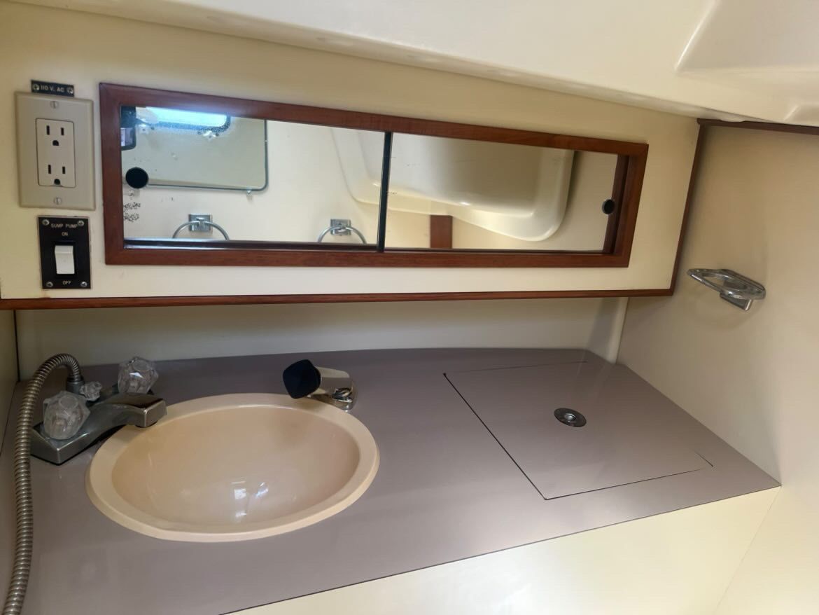 Bathroom area with sink and mirror in a 1988 Pearson 28.