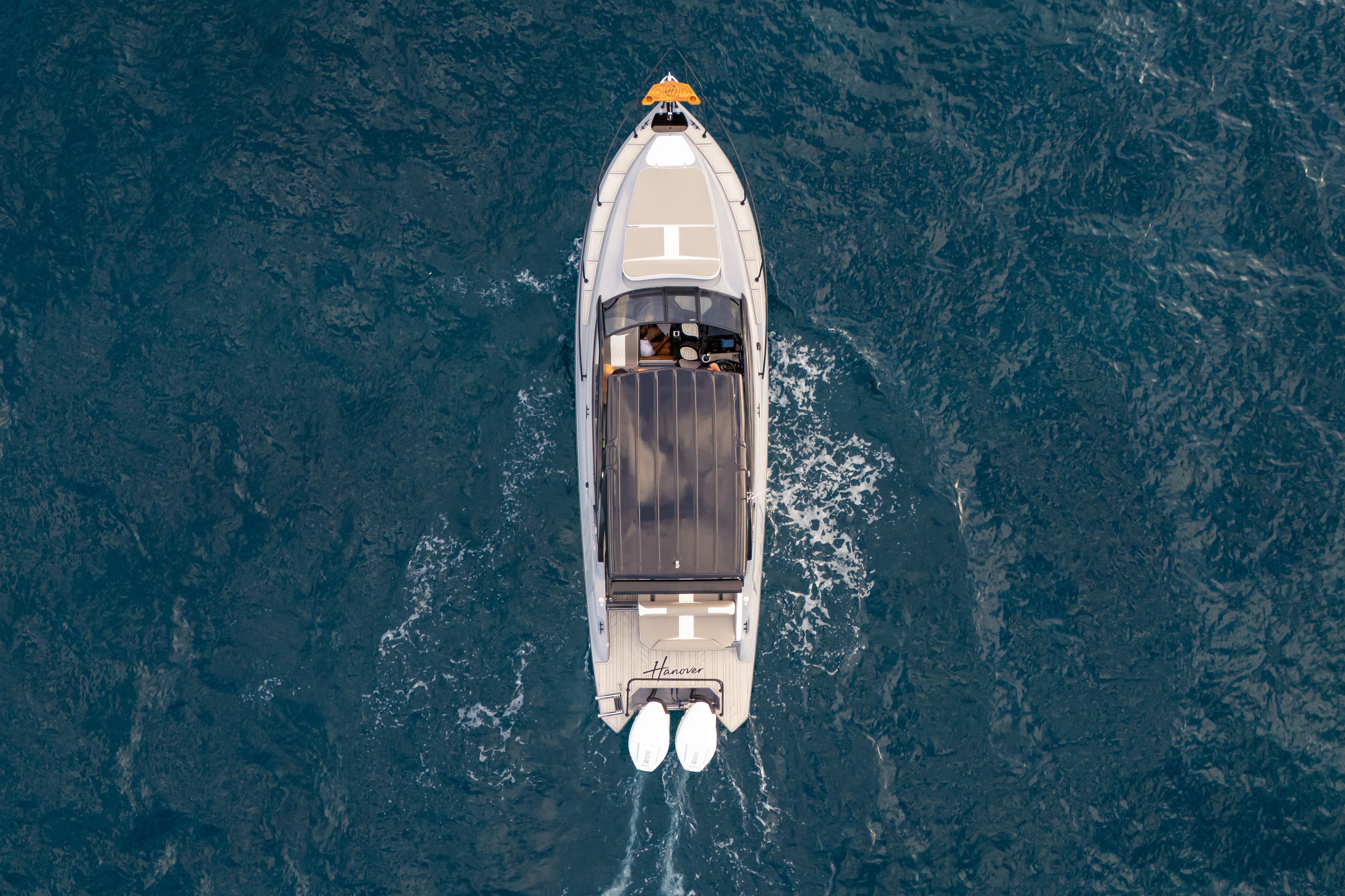 Aerial view of 2026 Hanover 305 boat cruising on open water.