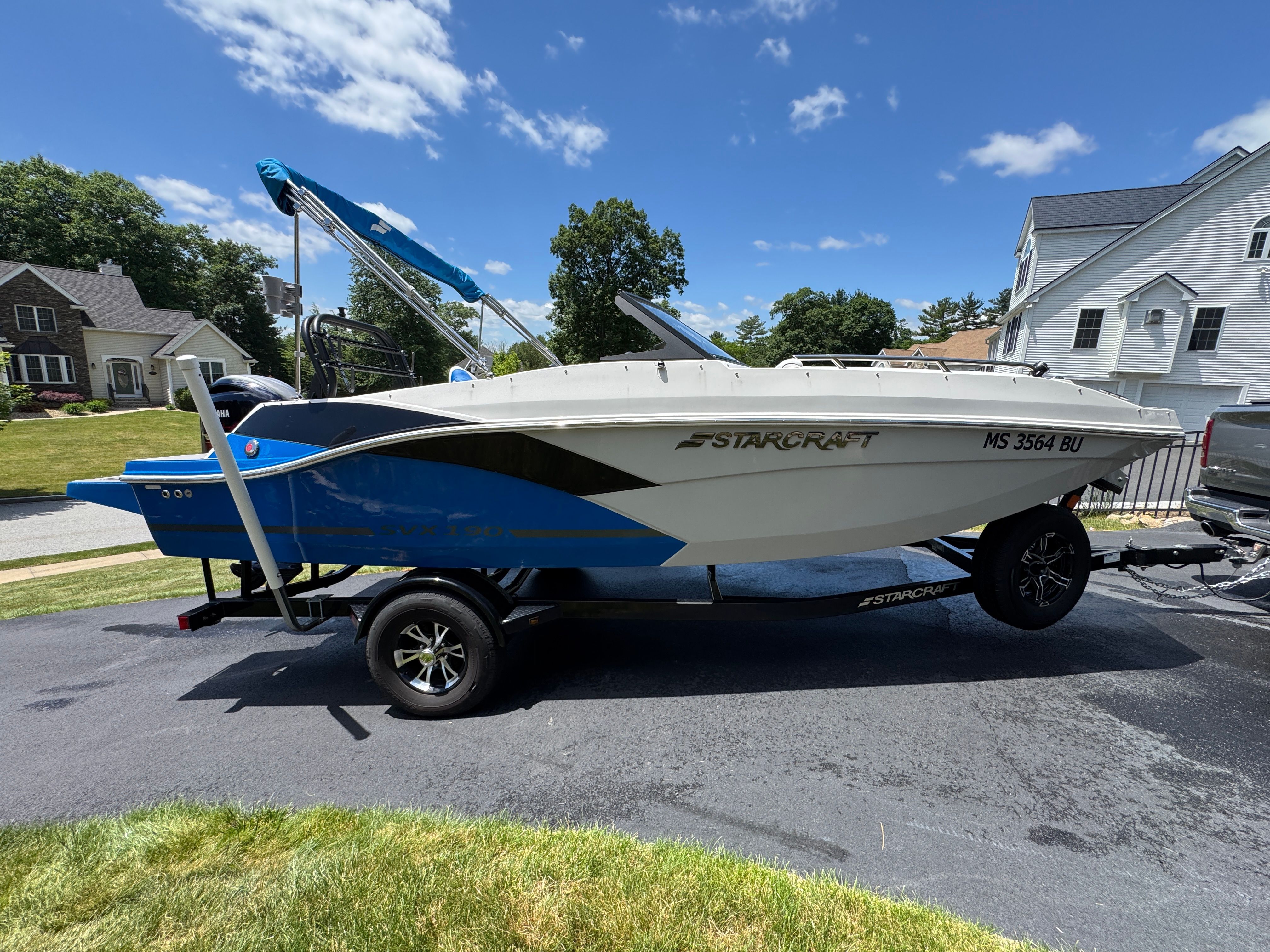 2023 Starcraft SVX 190 OB boat on trailer in residential area.
