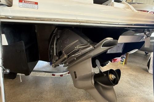 2027 Regal 2000 ES boat's outboard motor and propeller in a showroom setting.