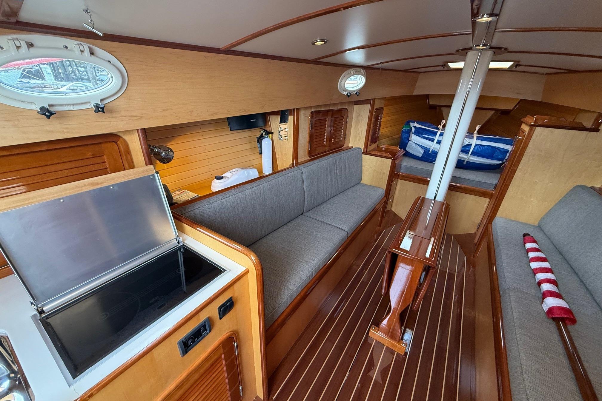 Interior of 2015 Hinckley DS 42 sailboat with wood finish and modern amenities.
