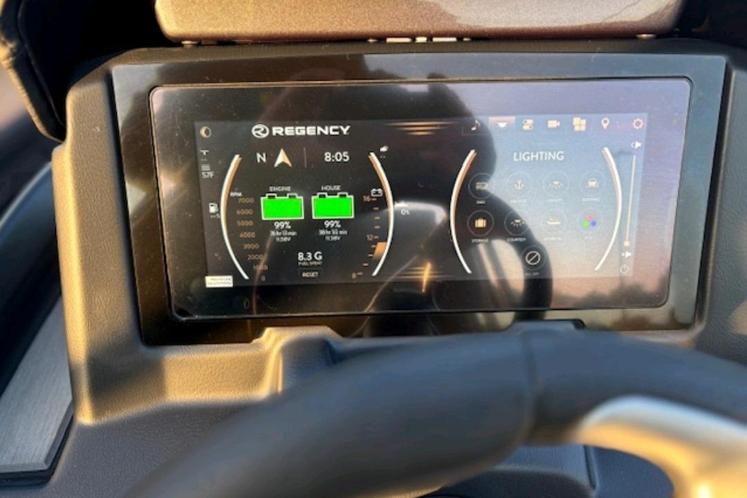 Dashboard display of 2026 Regency 230 DL boat showing engine and lighting controls.
