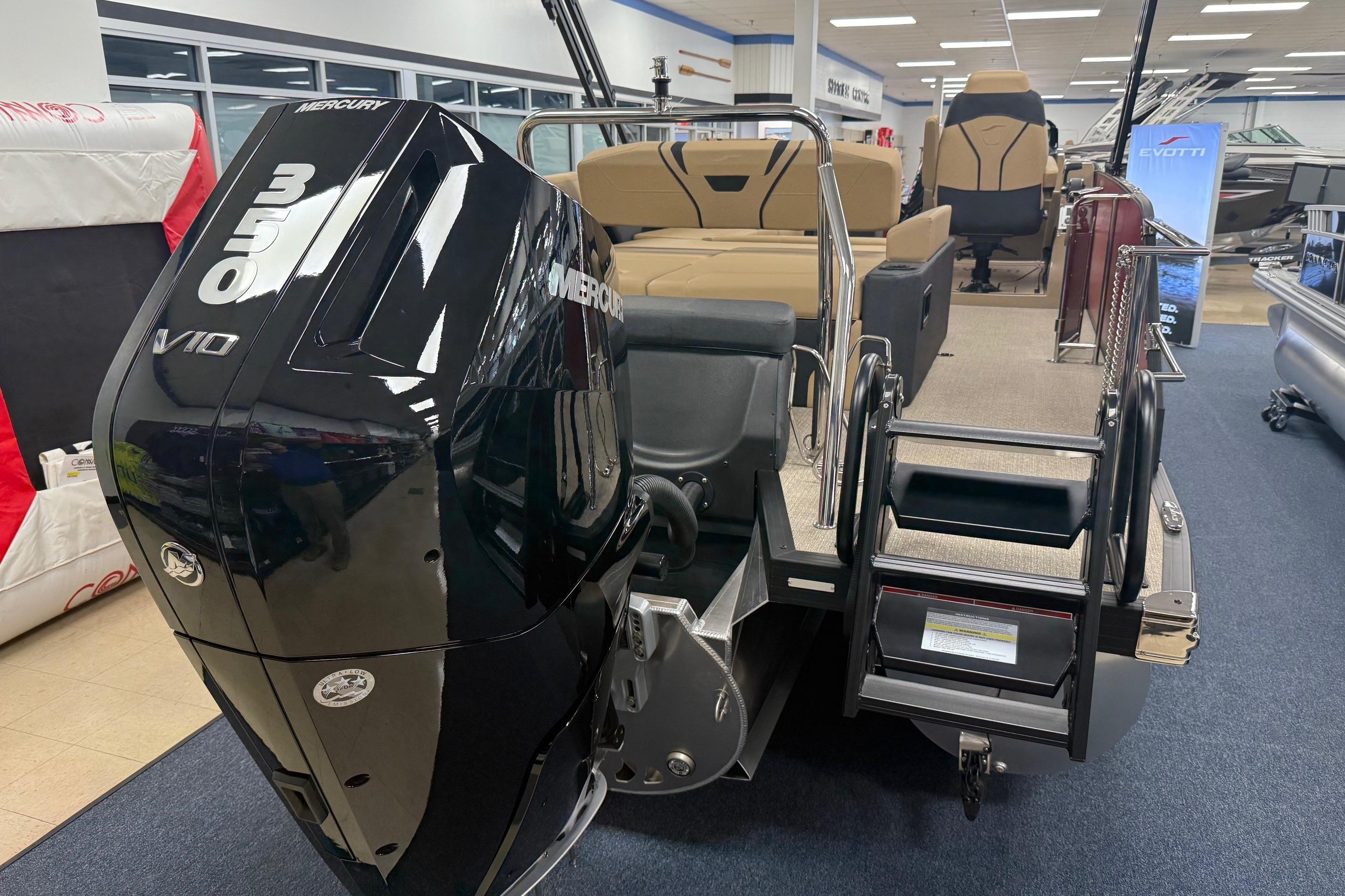 2026 Evotti 725CS boat with Mercury 350 V10 engine displayed indoors.