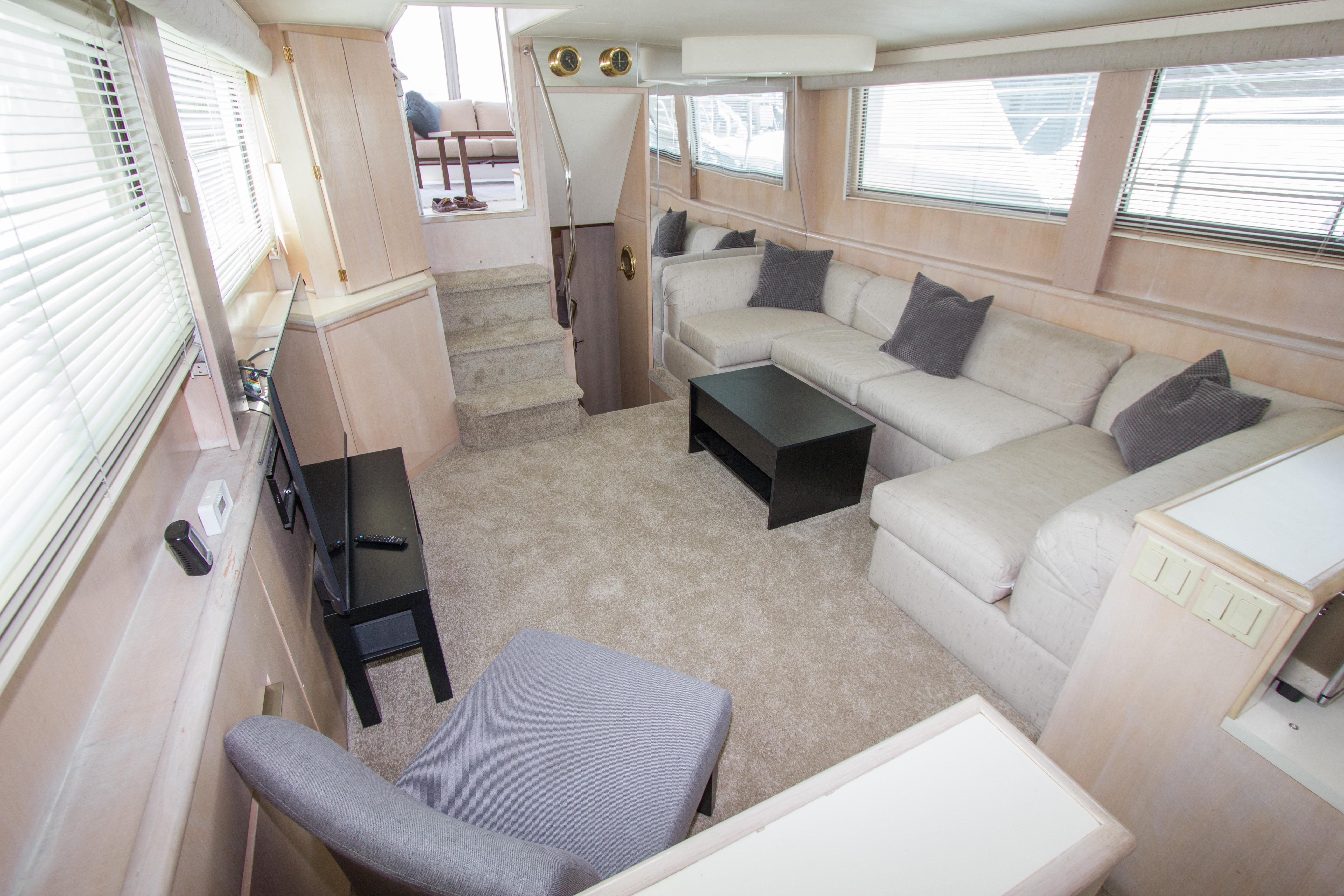 Luxurious interior of 1994 Hatteras 52 Cockpit Motor Yacht with plush seating and modern decor.