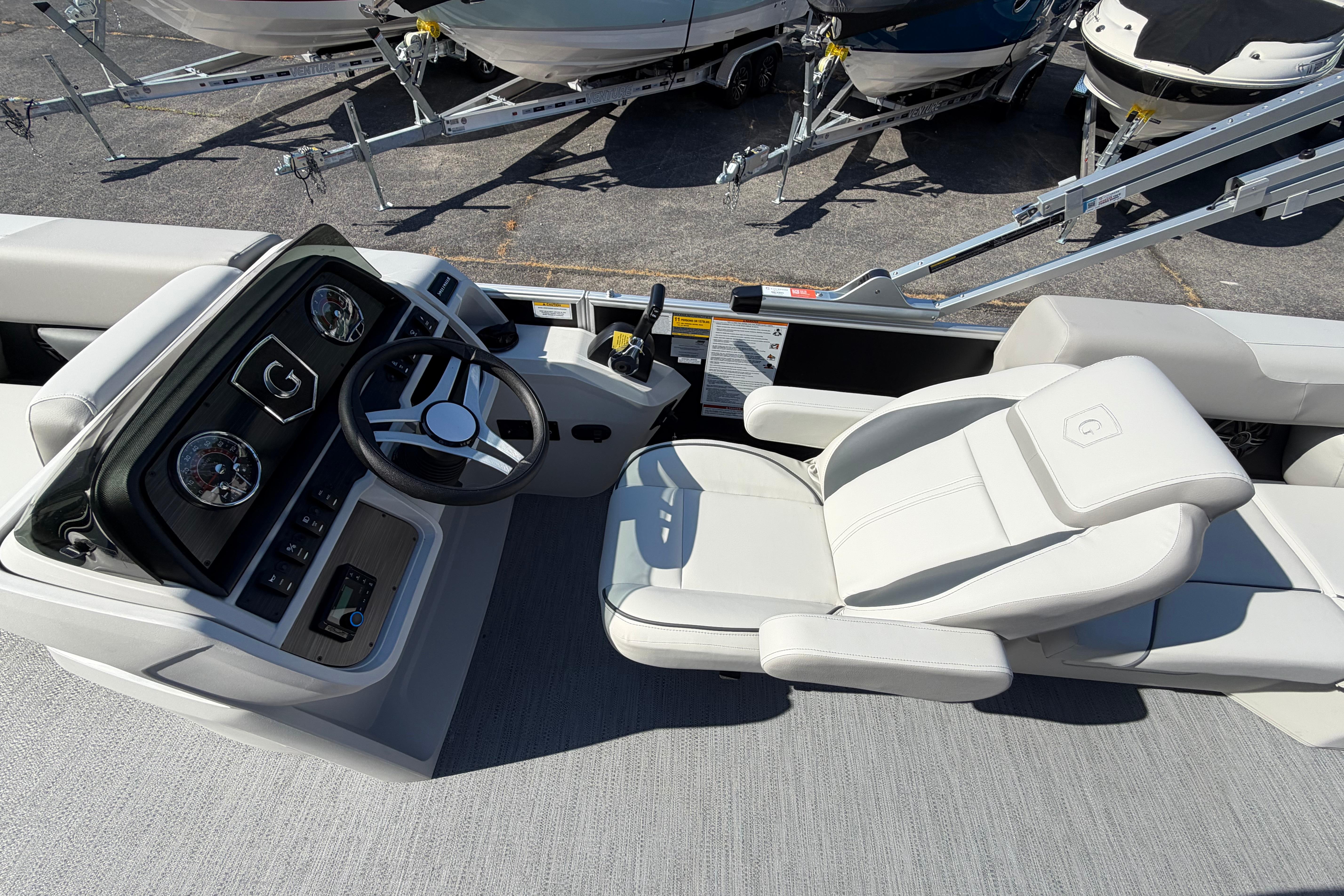 Captain's seat and helm of 2026 Godfrey Sweetwater 2086 SBC pontoon boat.