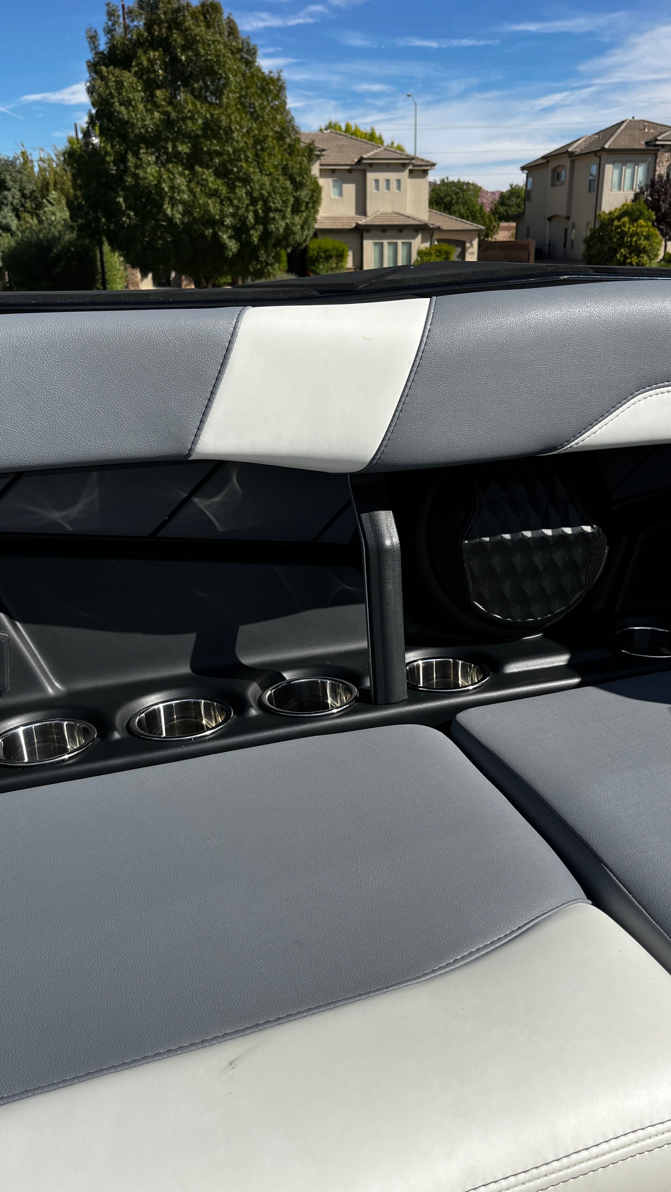 The image shows the gray and white seats of a 2023 Malibu Wakesetter 26 LSV with cup holders.
