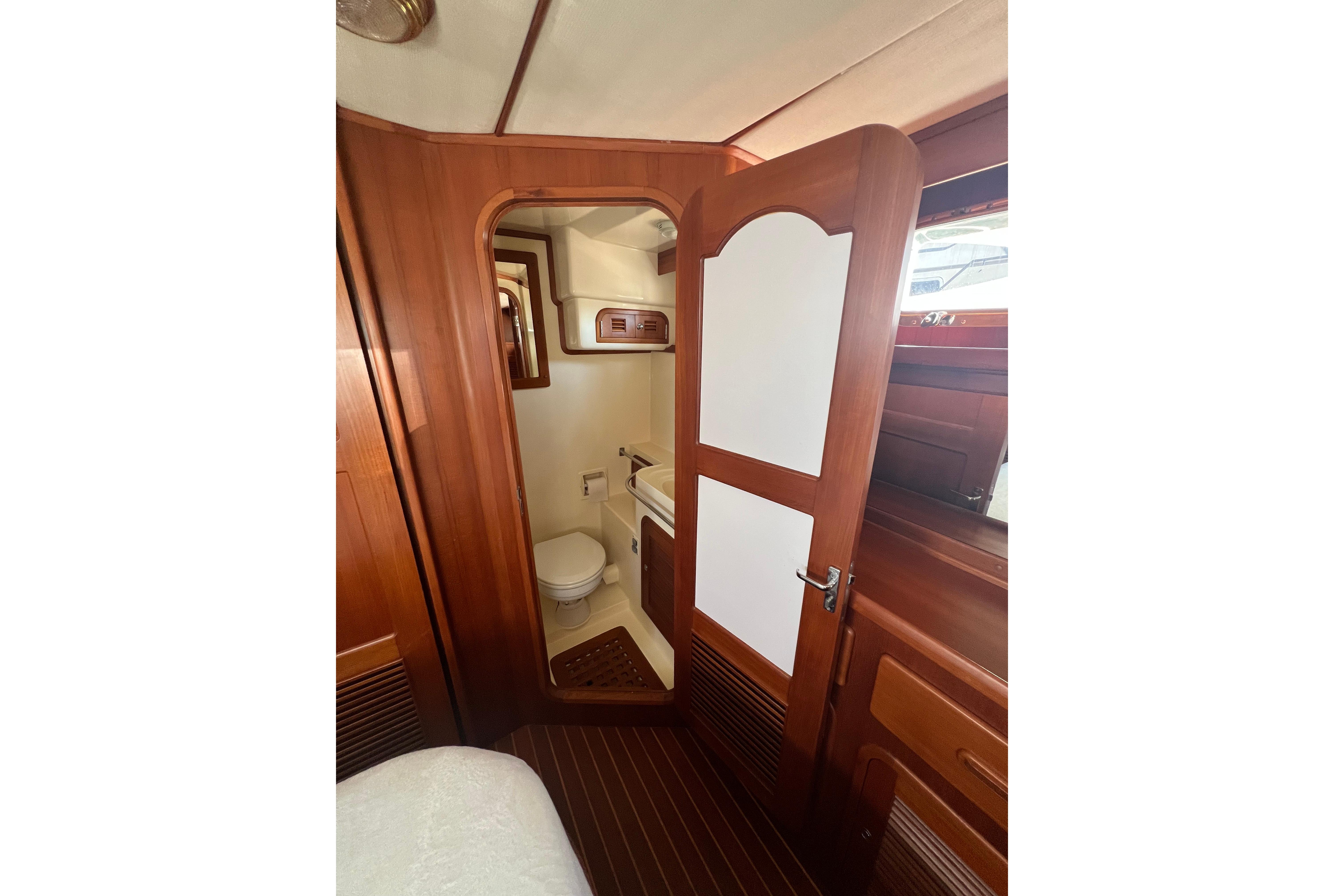 Interior of 2007 Heritage East 36 Sundeck Trawler, featuring a wooden bathroom door.