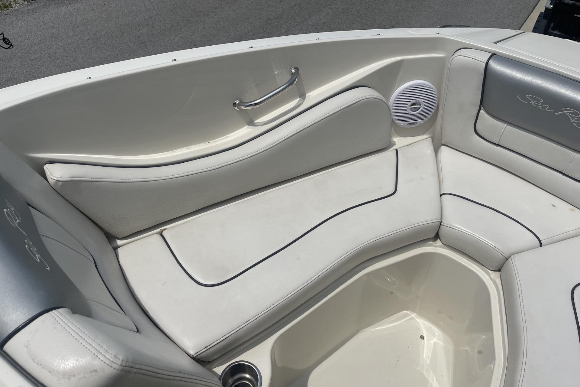 2010 Sea Ray 230 Bow Rider Select interior with white cushioned seating and speaker.