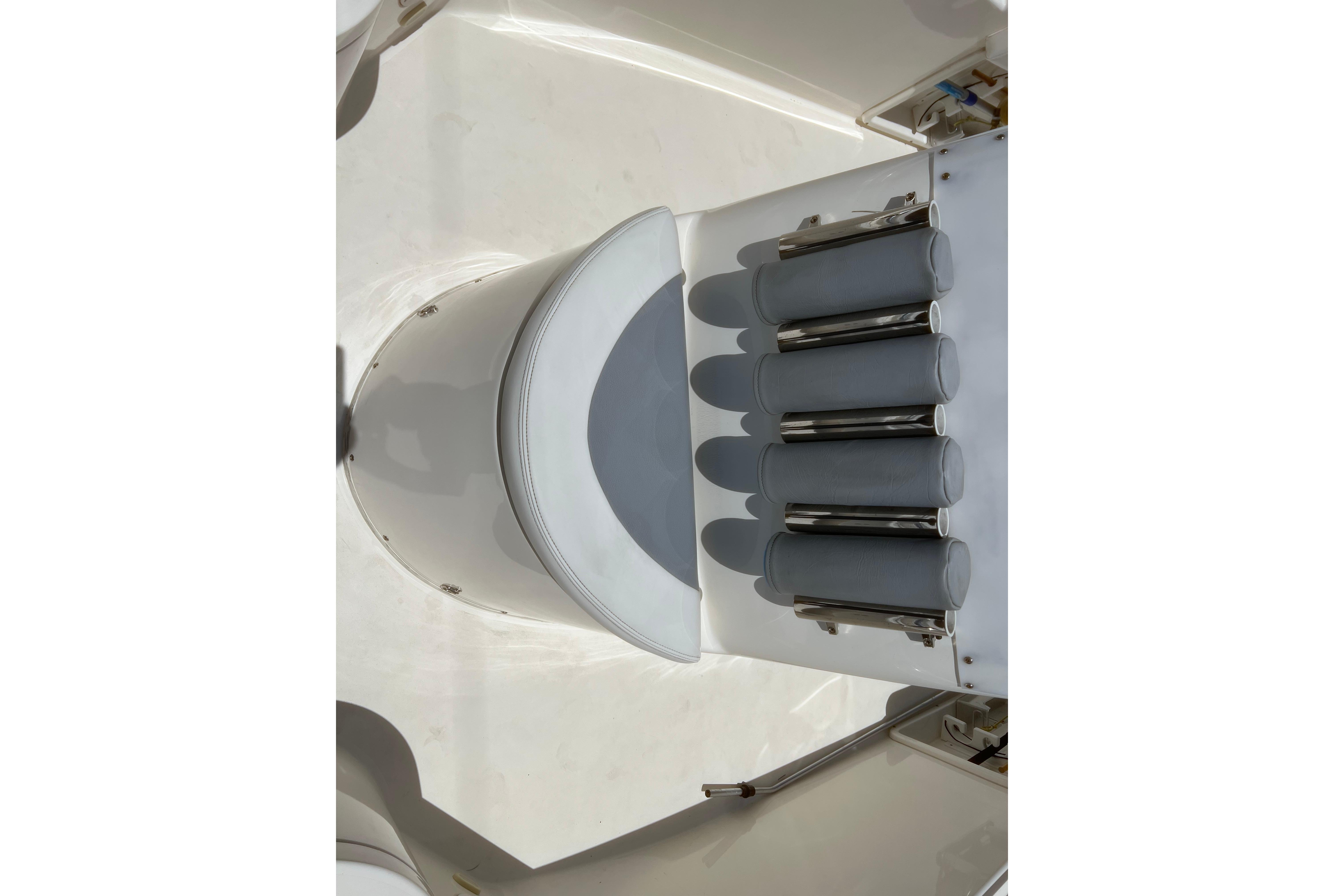 2018 Cobia 201 Center Console boat with rod holders and seating.