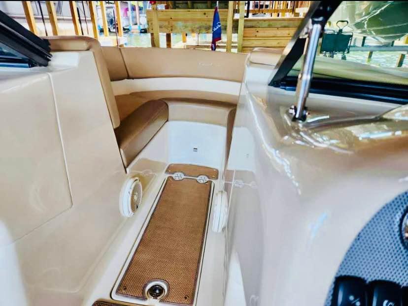 2016 Chris-Craft Carina 21 boat interior with beige seating and wood accents.