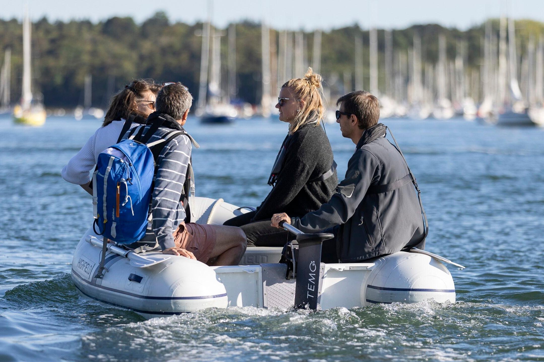 Four people on a Highfield Roll-Up 250 KAL inflatable boat, 2025 model.