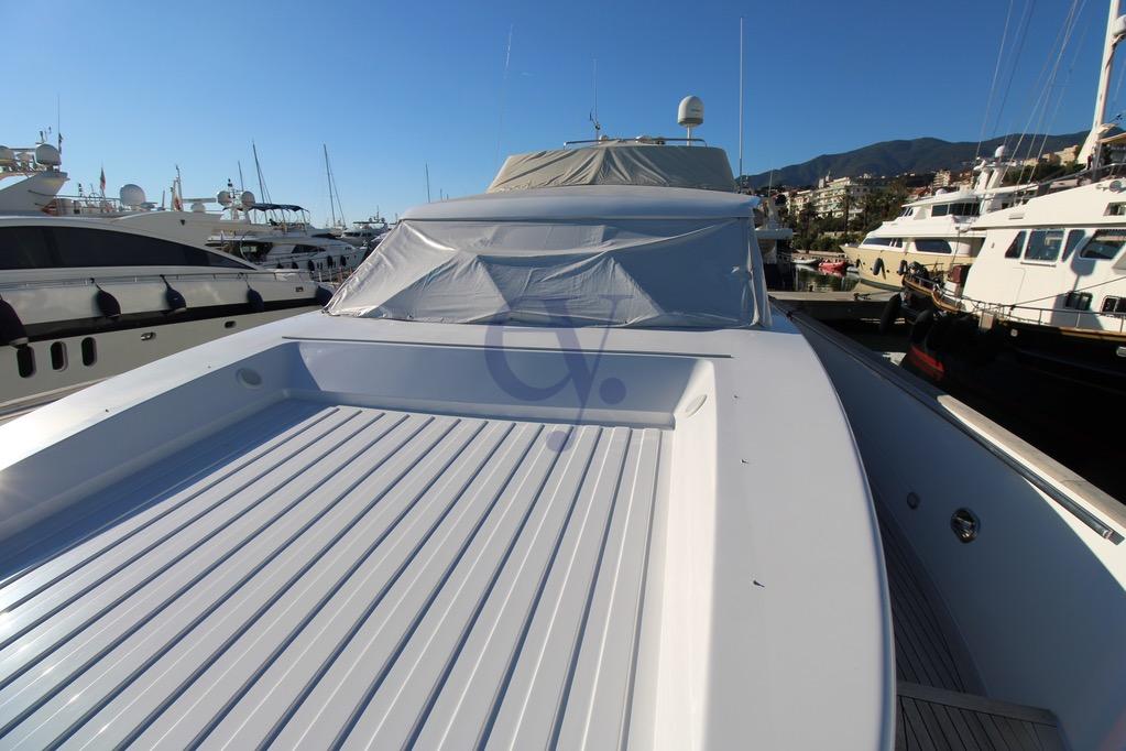 1996 Canados 23 yacht docked in a marina under clear blue skies.