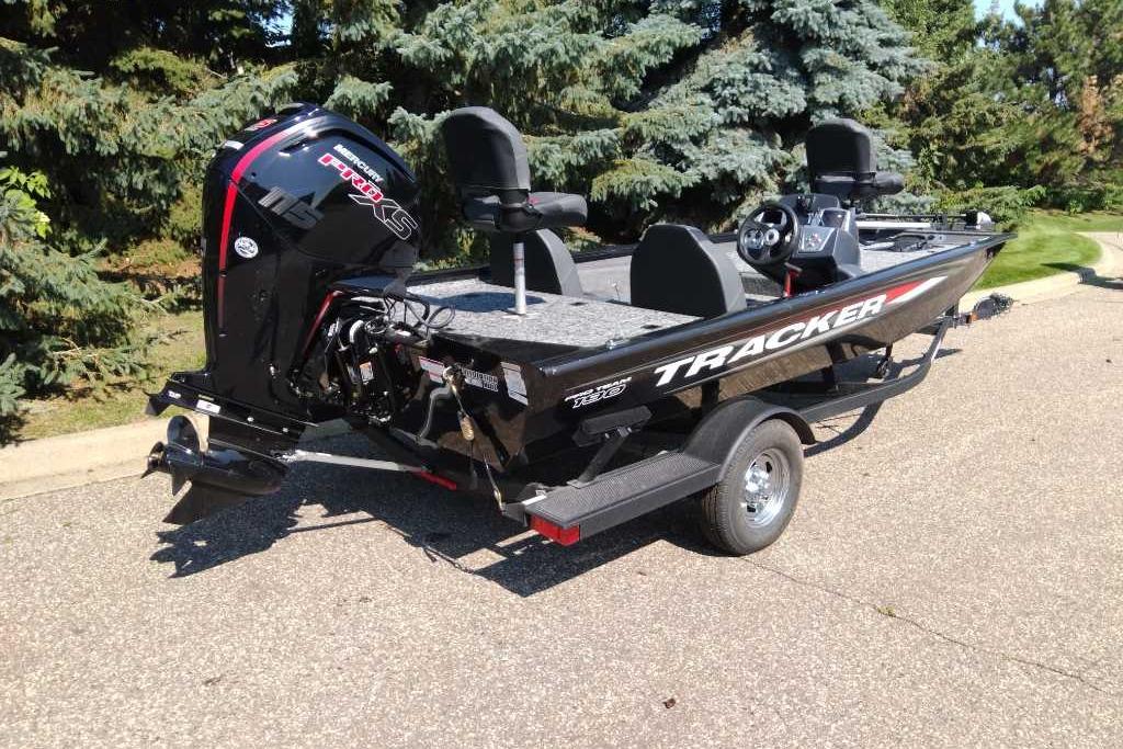 2026 Tracker Pro Team 190 boat on trailer, parked outdoors near trees.