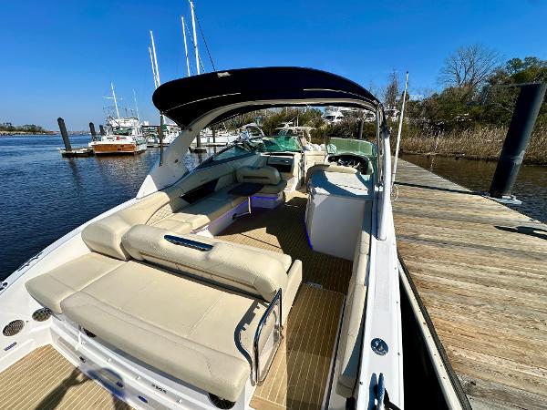 2018 Regal 3300 at dock with spacious cockpit and beige upholstery.