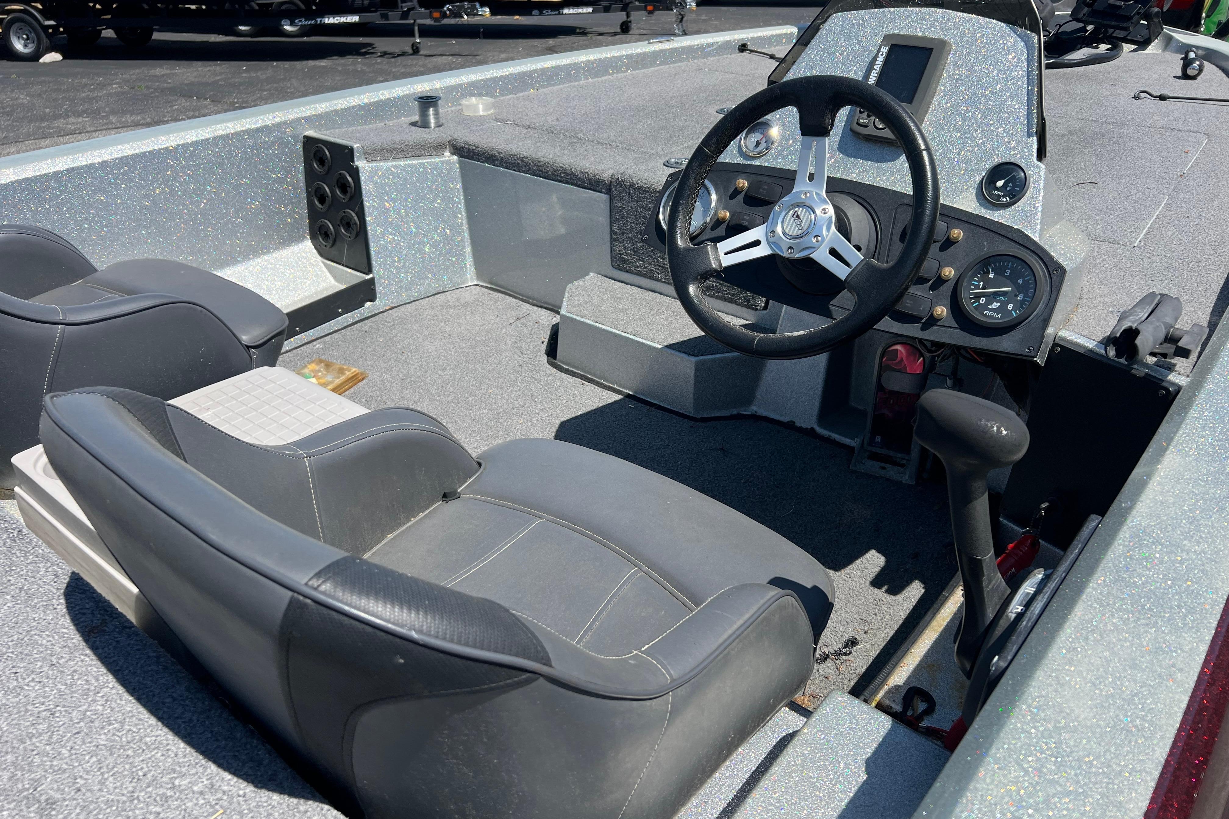 2015 Stratos 186 VLO boat interior with steering wheel and seating.