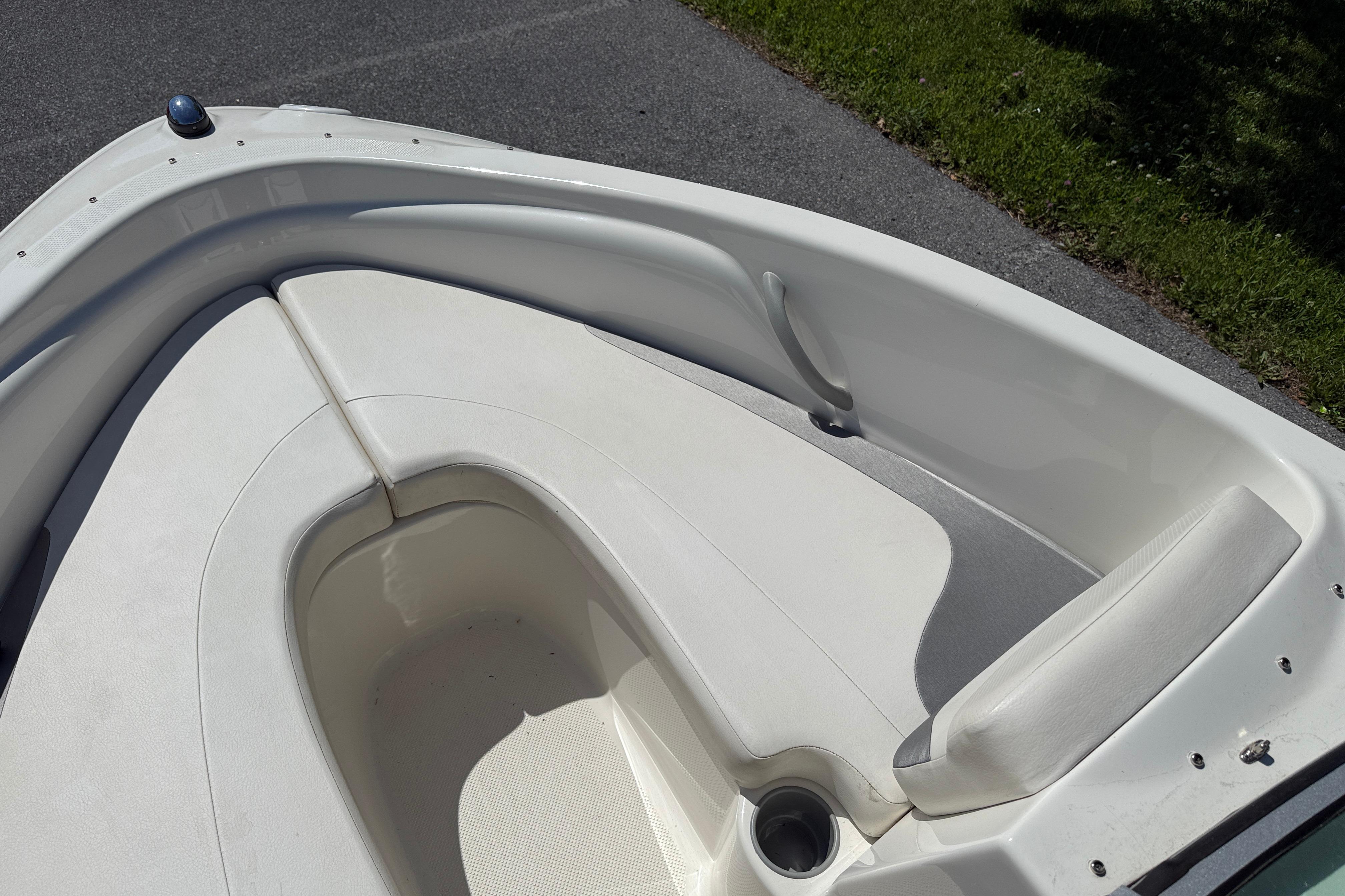 2009 Bayliner 175 boat interior with white seating and cup holder.