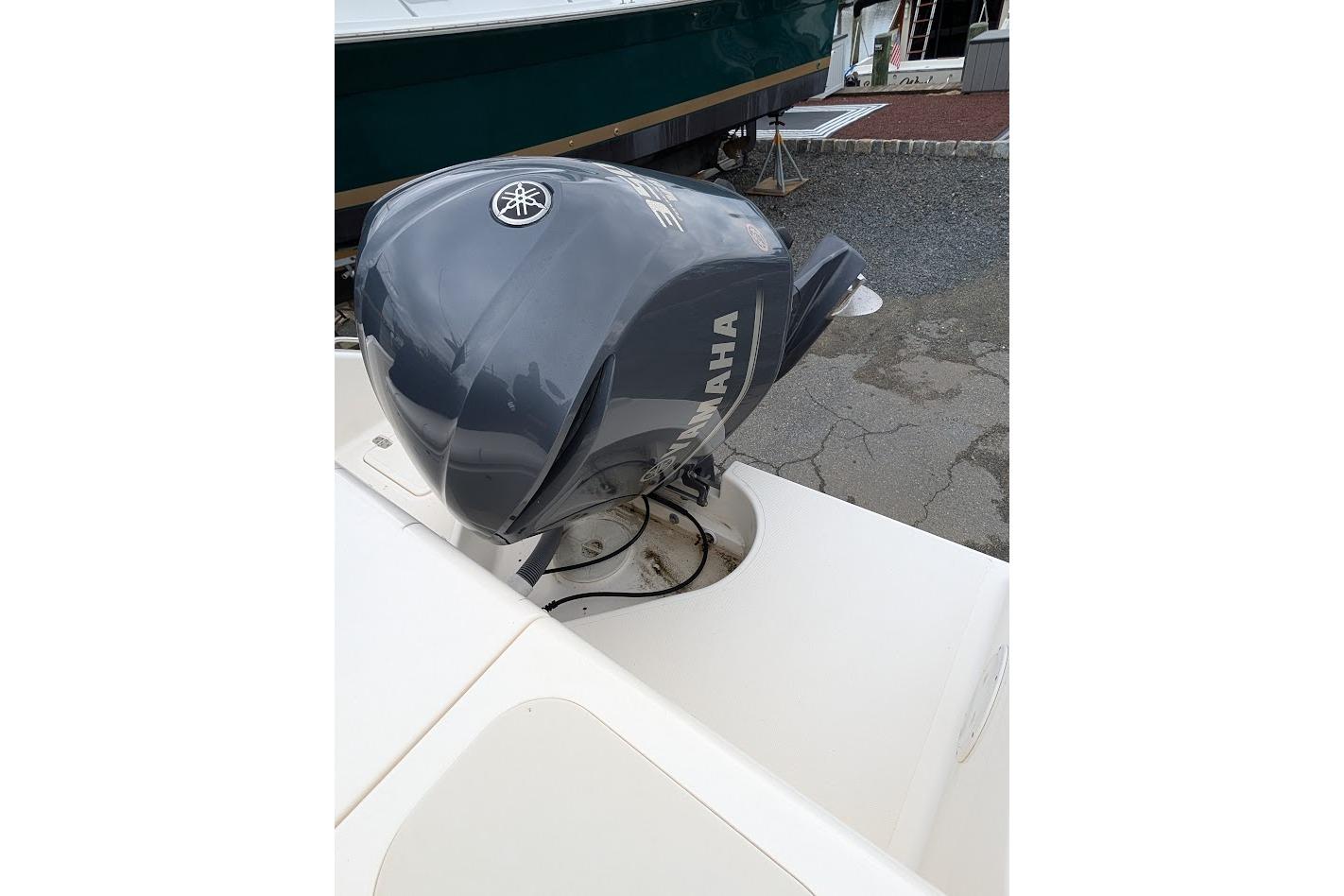 2011 Pursuit DC 265 Dual Console with Yamaha outboard motor, docked on pavement.