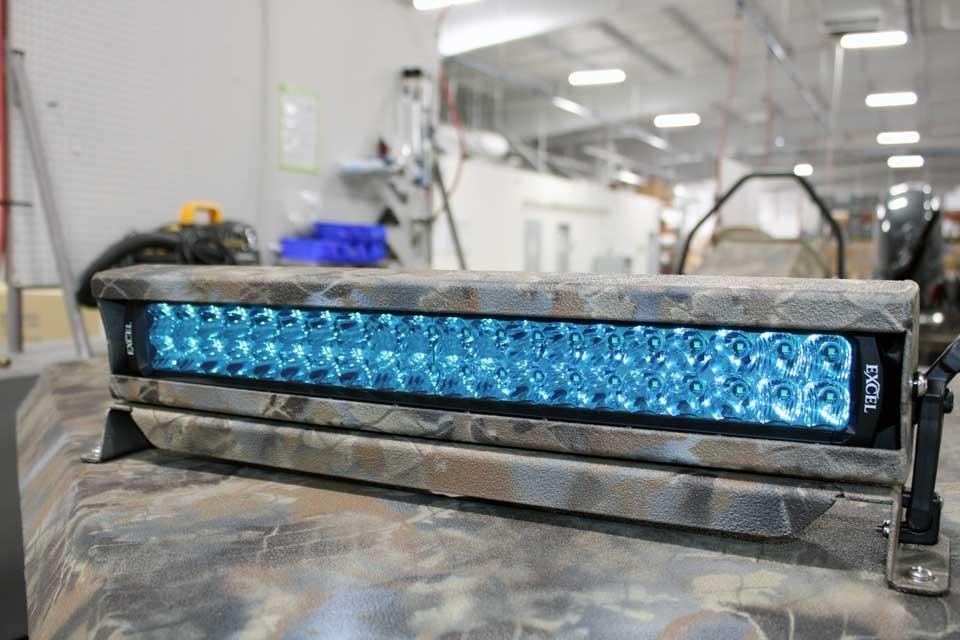 2026 Excel Switchblade light bar with blue LEDs in a workshop setting.