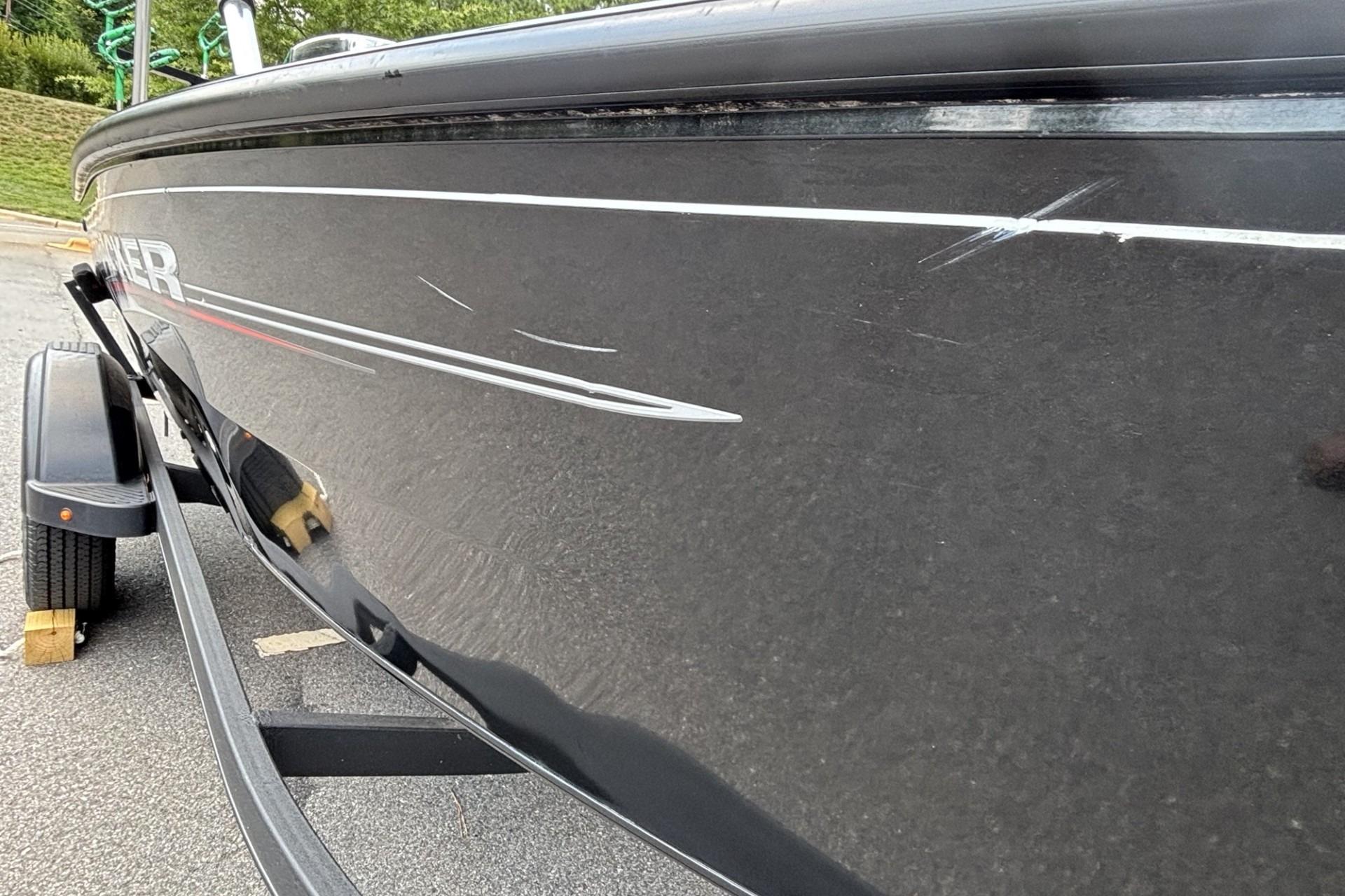 2022 Tracker Super Guide V-16 T boat with visible scratches on the side.