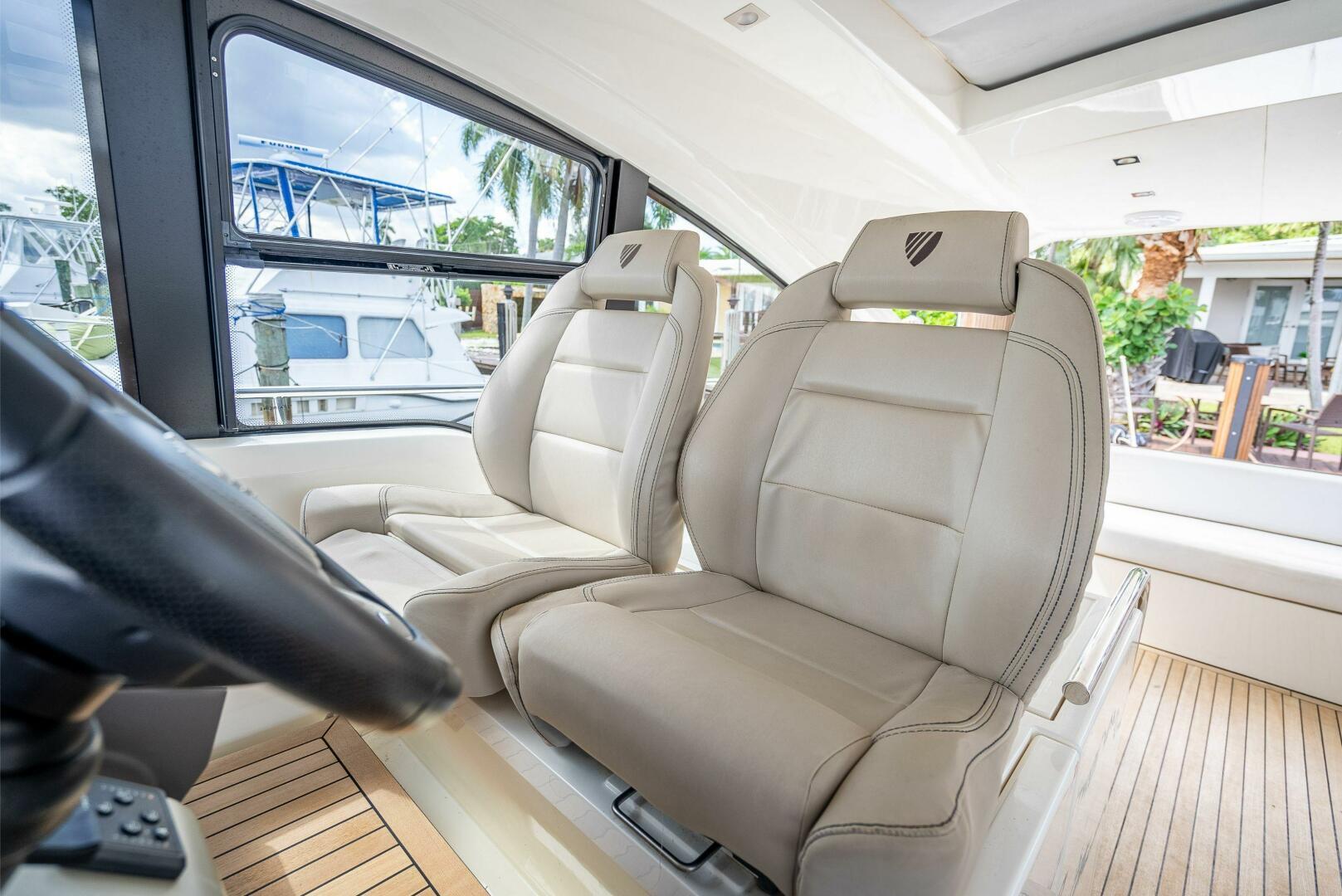 2015 Fairline Targa 48 Open interior with beige leather seats and wooden flooring.