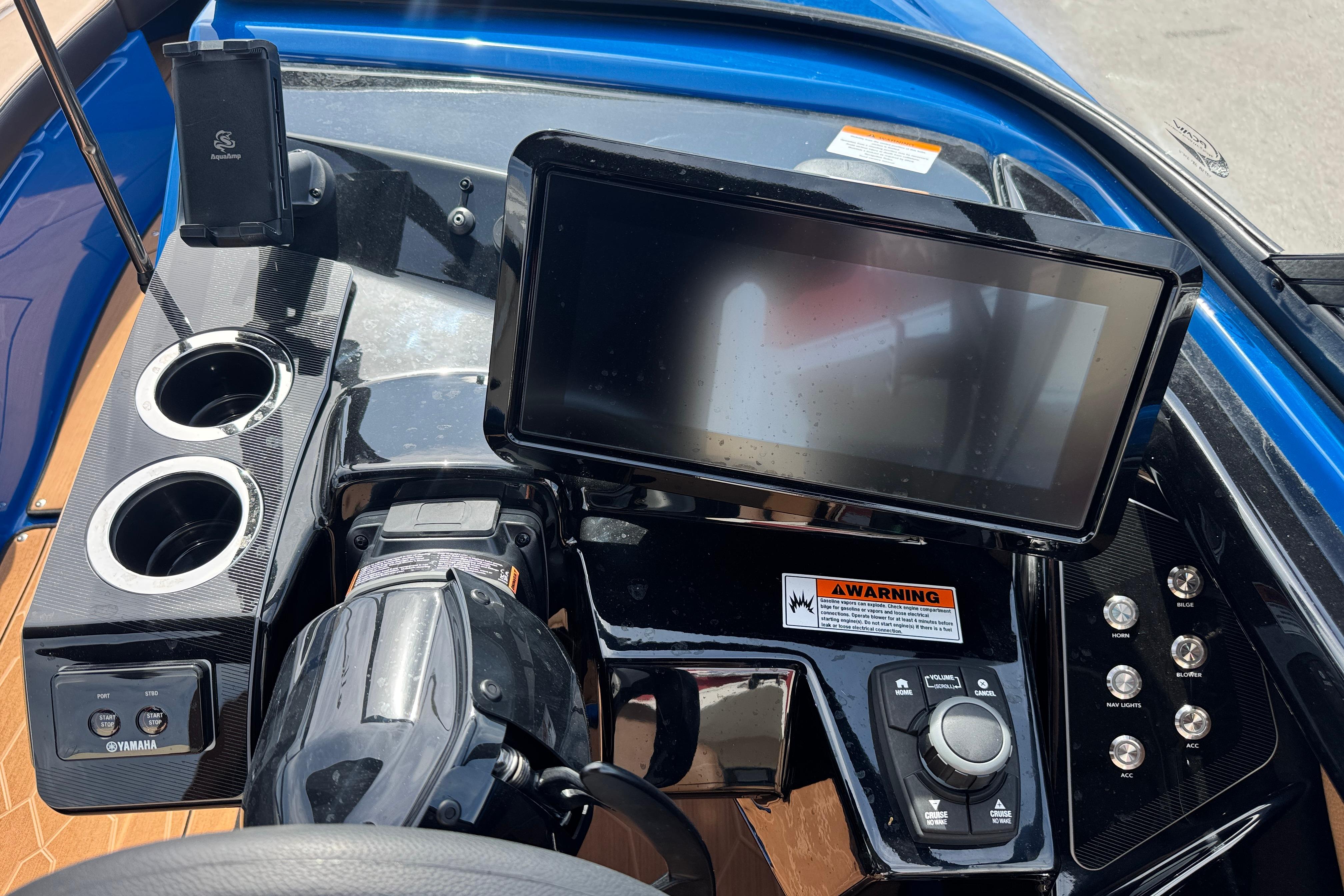 2026 Yamaha Boats 255XD dashboard with touchscreen, controls, and cup holders.