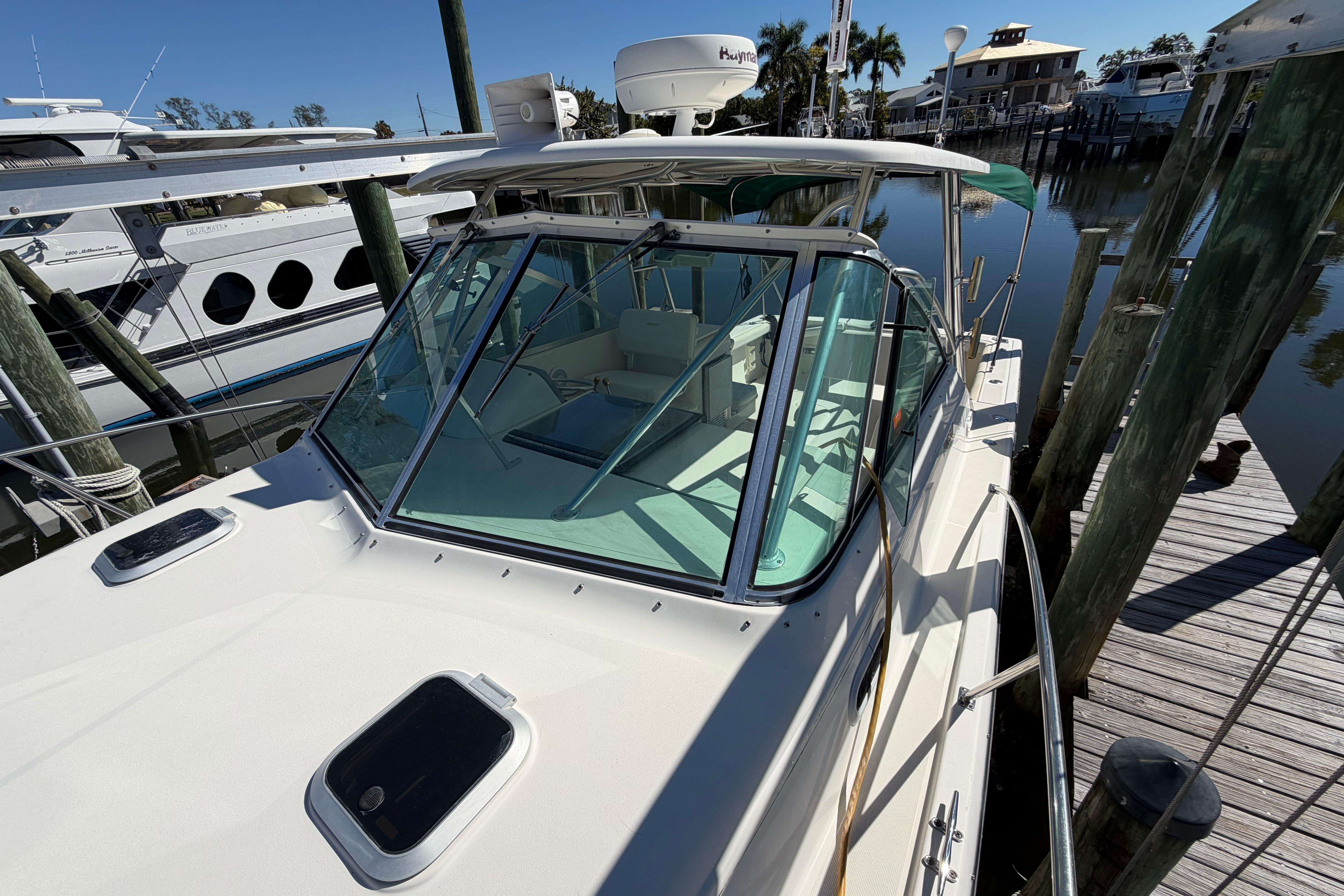 2001 Pursuit 3000 Express boat docked at marina, clear sunny day.