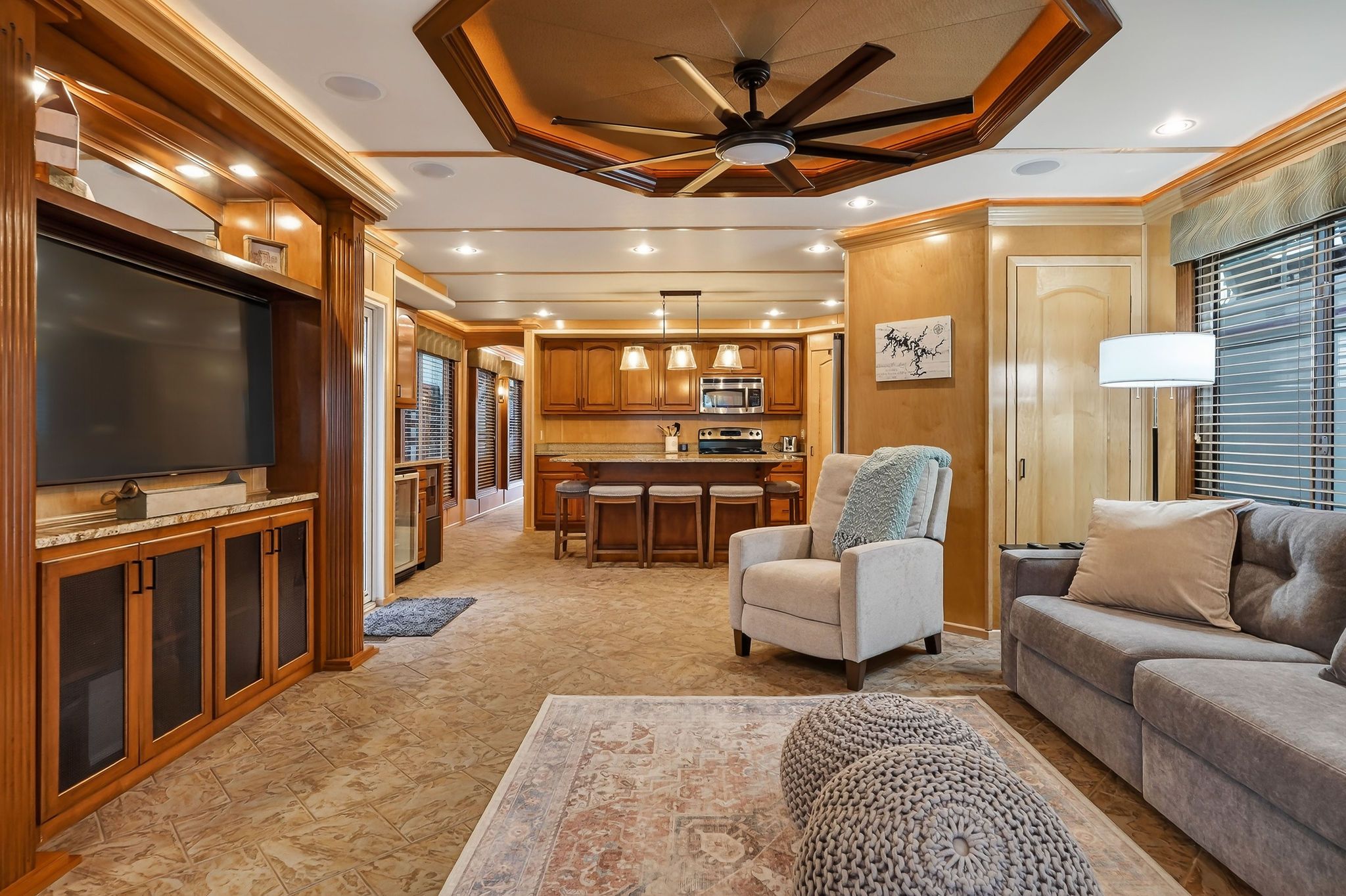 Luxurious interior of a 2010 Houseboat Throughbred with modern kitchen and living area.