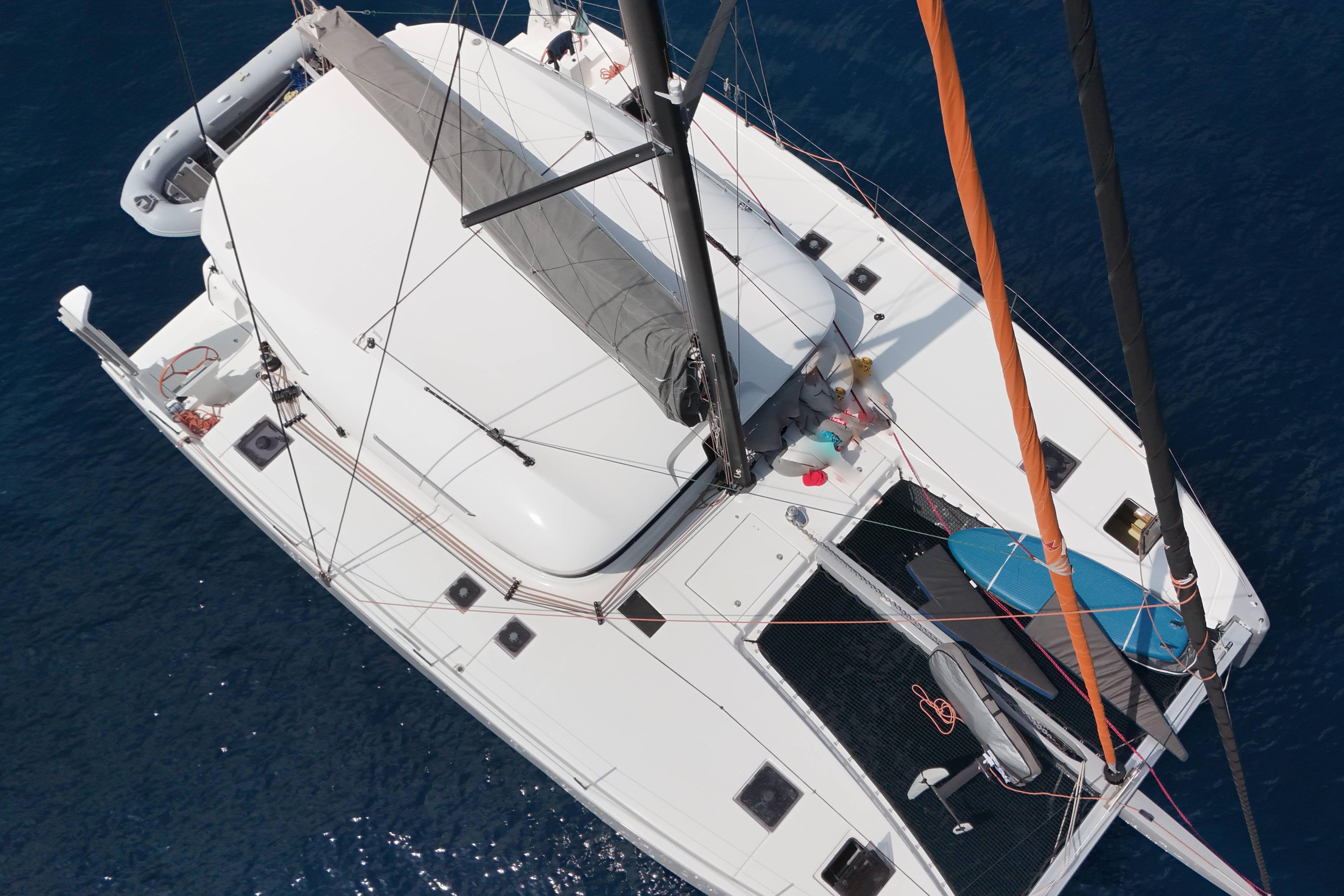 Aerial view of 2023 Excess 14 catamaran sailing on blue ocean waters.