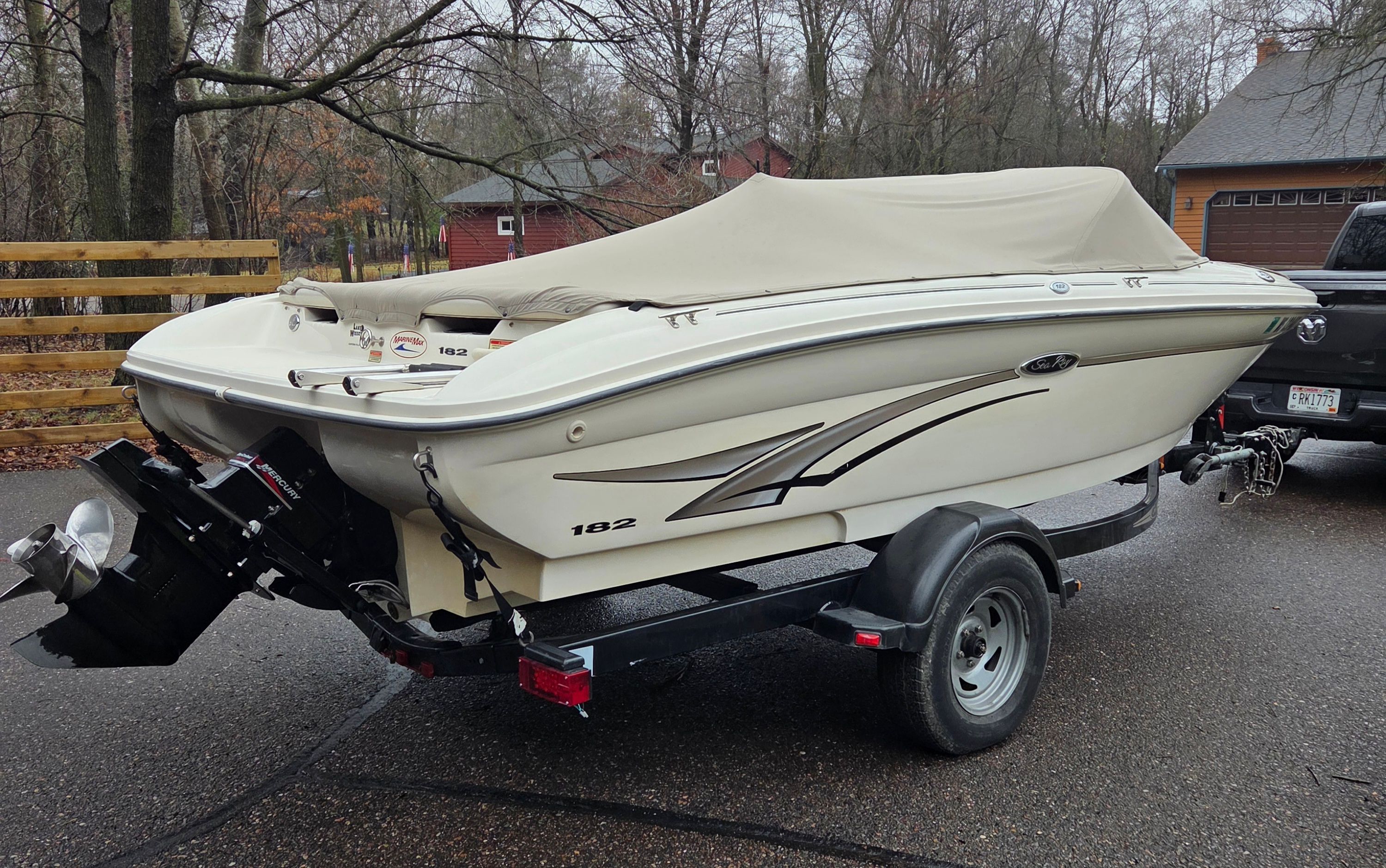 2002 Sea Ray 182 boat parked on trailer outdoors.