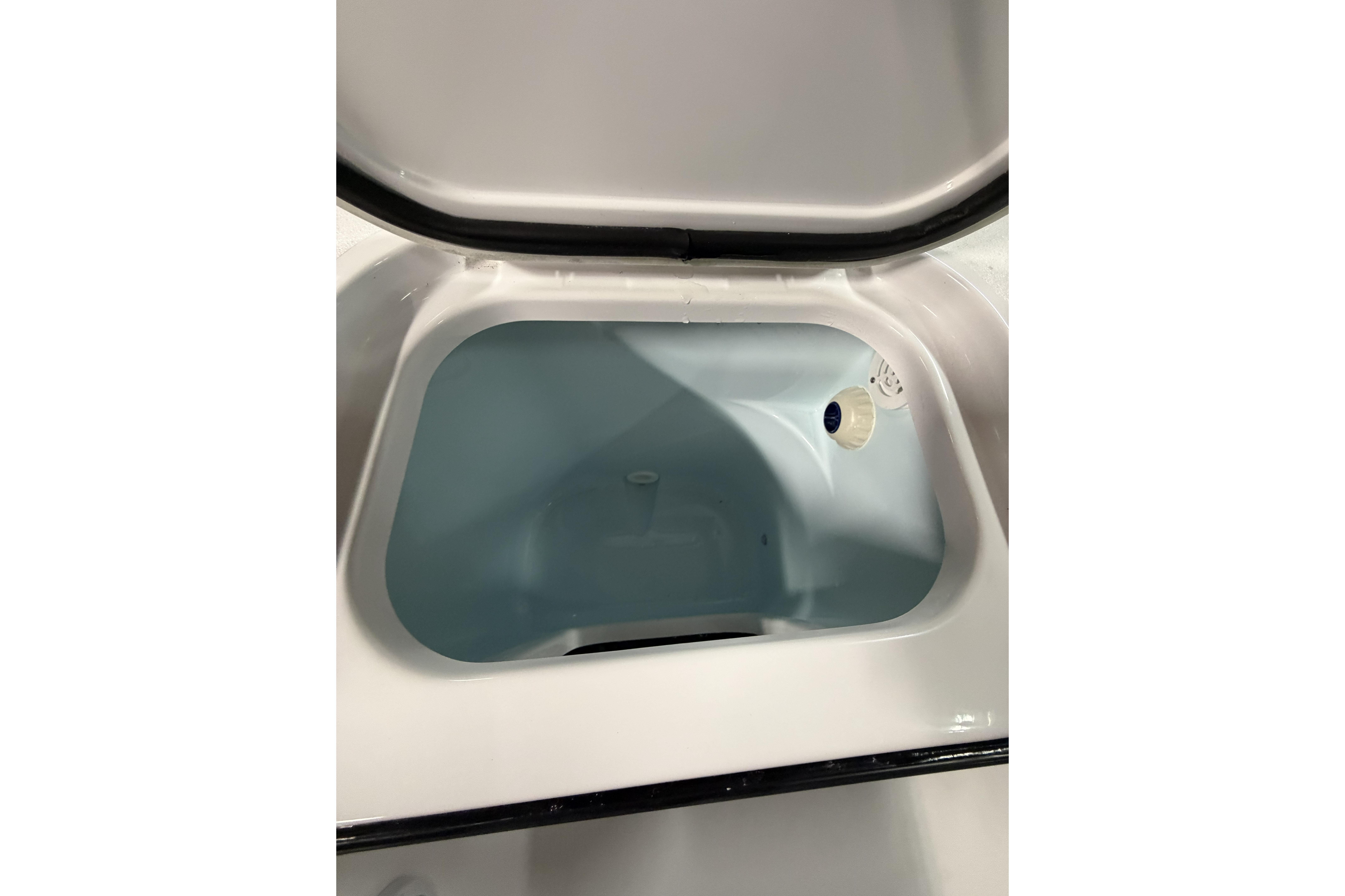 2026 Sportsman Open 232 Center Console storage compartment interior view.