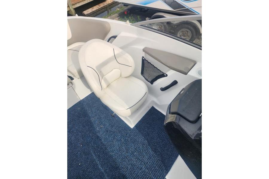 2012 Sea-Doo 180 Challenger boat interior with white seating and blue carpet.