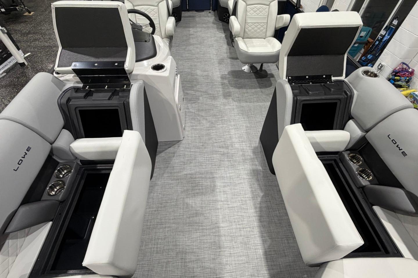 2026 Lowe SS 230 WT boat interior with open storage compartments and cup holders.