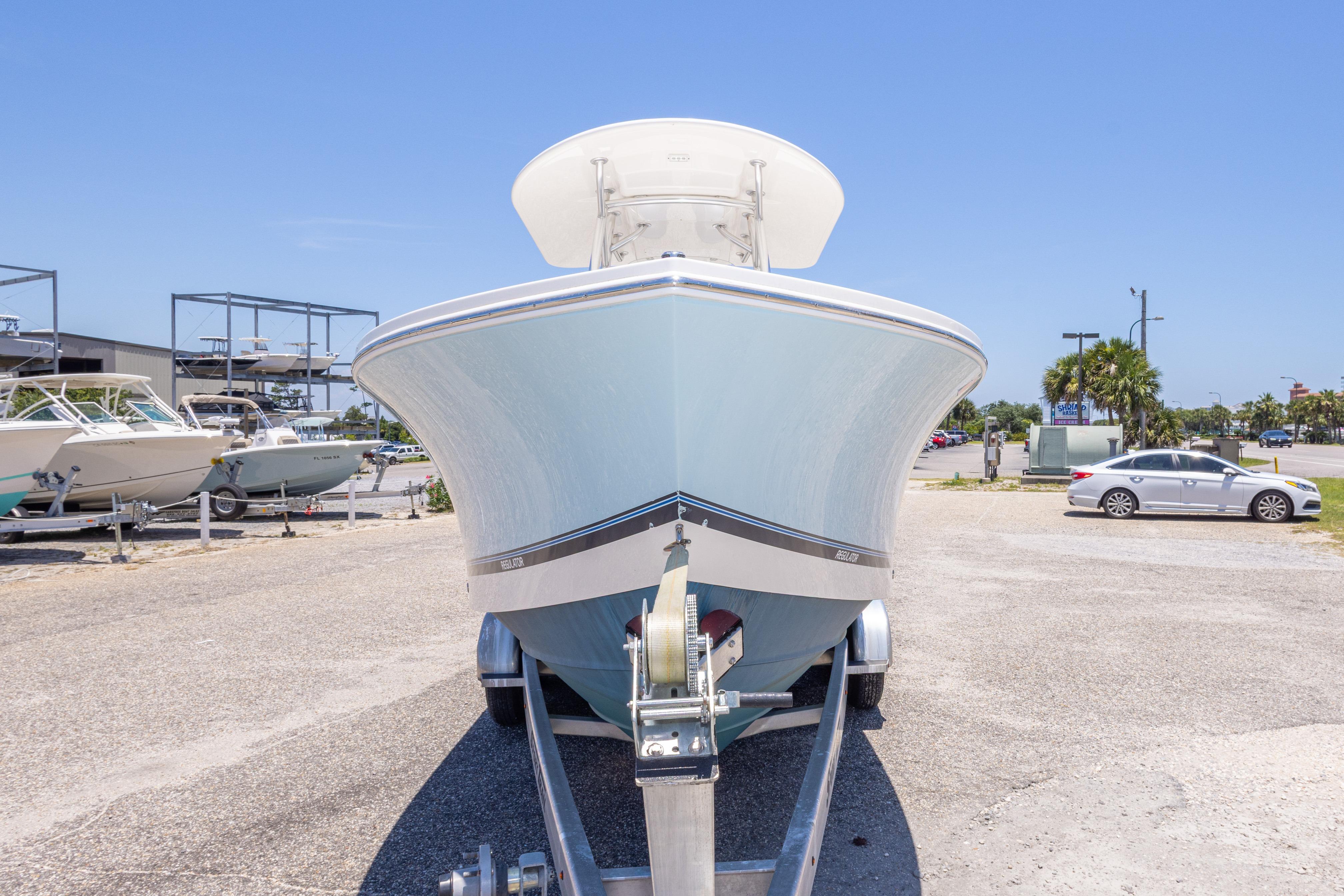 2019 Regulator 23 Center Console boat on trailer in sunny outdoor setting.