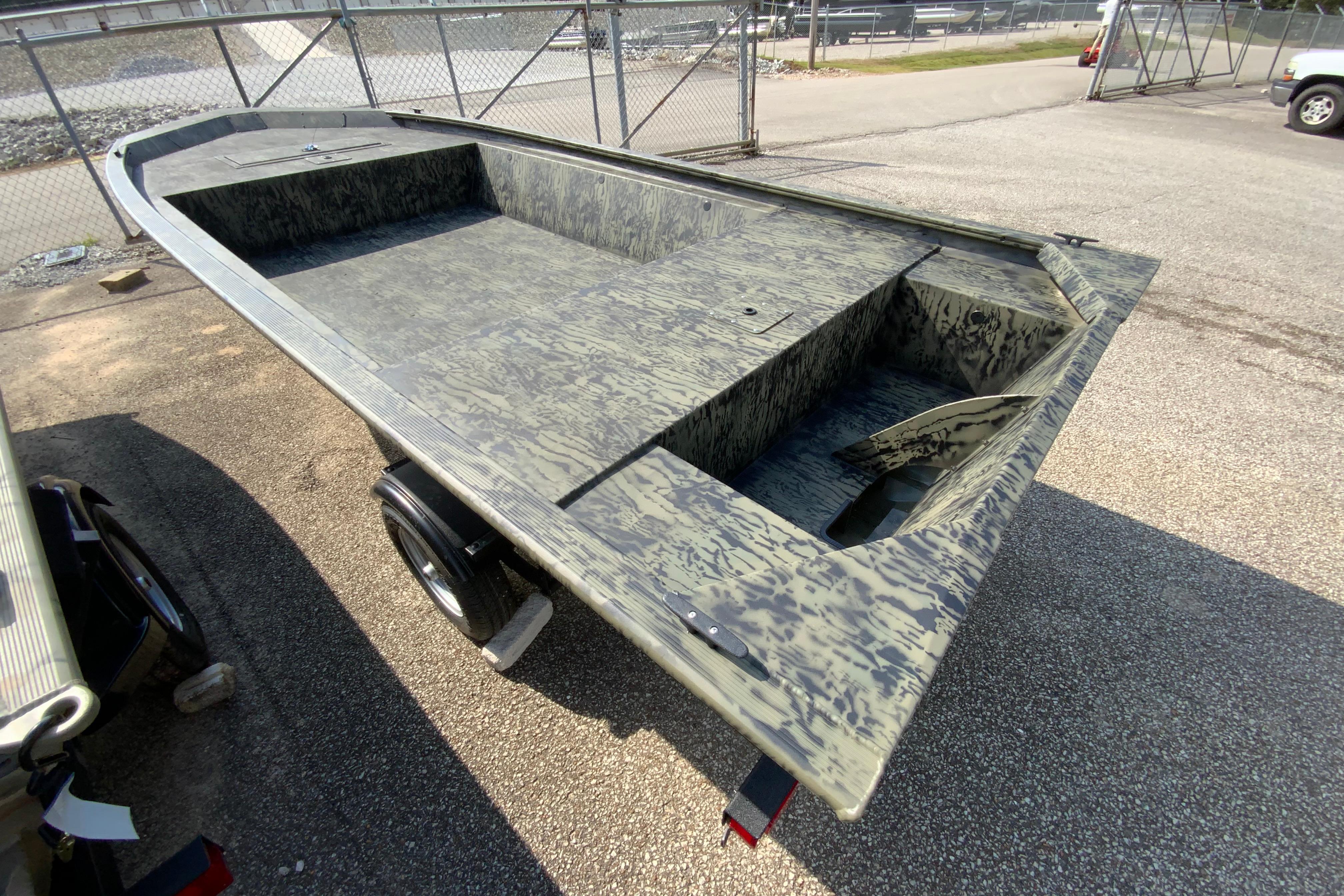 2026 Tracker Grizzly 1648 Utility boat with camouflage design on a trailer.