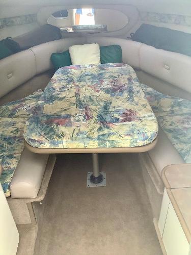 1998 Chaparral 2335 SS boat interior with cushioned seating and table.