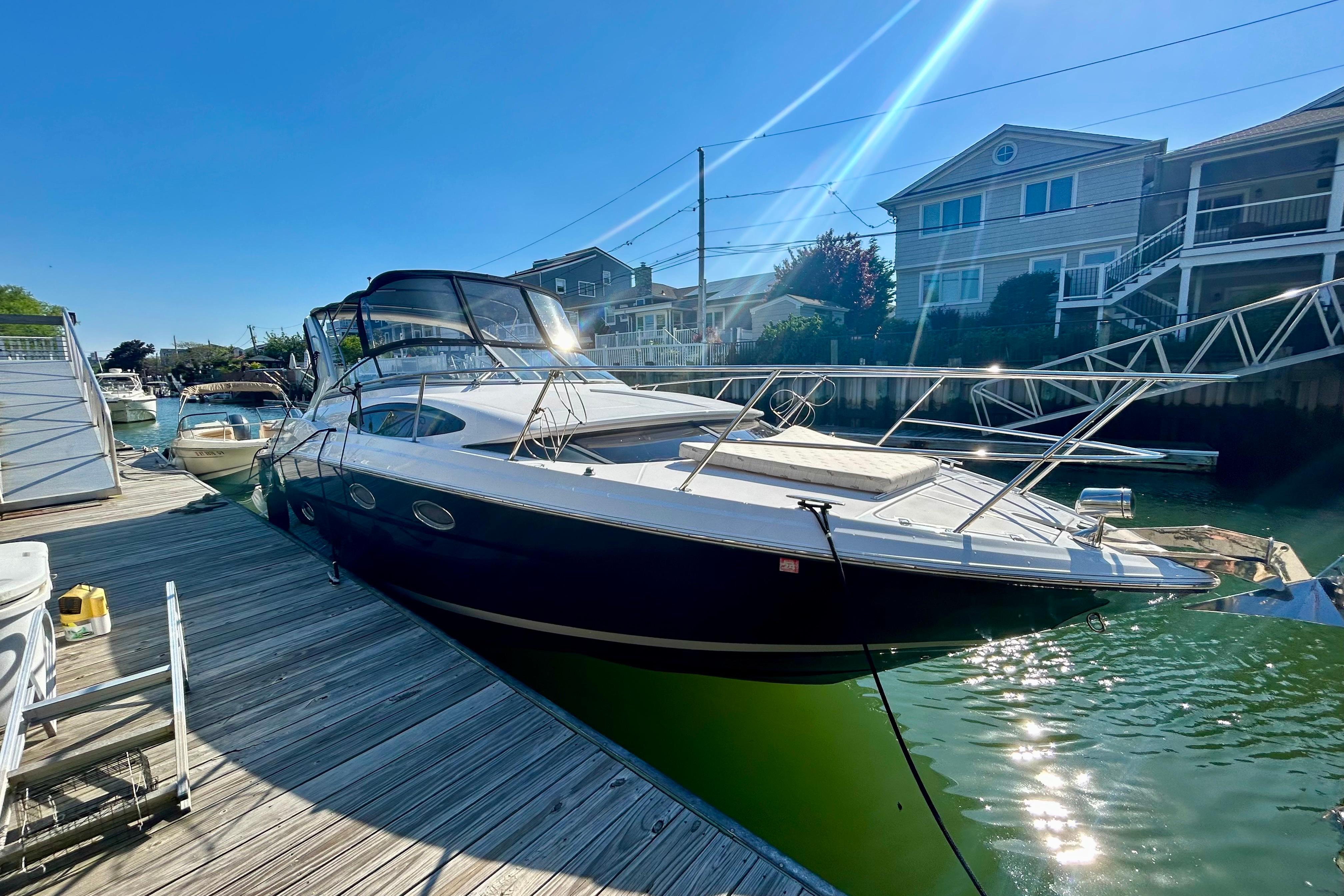 2012 Regal 35 Express Cruiser docked at a marina under clear blue skies.