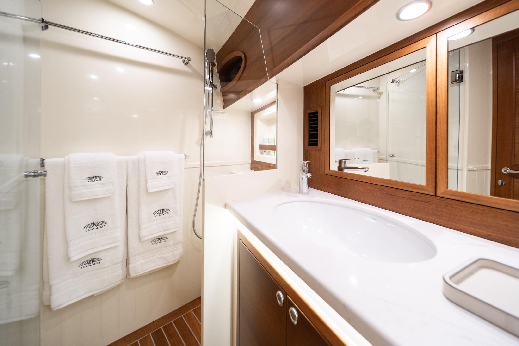Luxurious bathroom in 2026 Palm Beach Motor Yachts PB70, featuring elegant wood accents and modern fixtures.