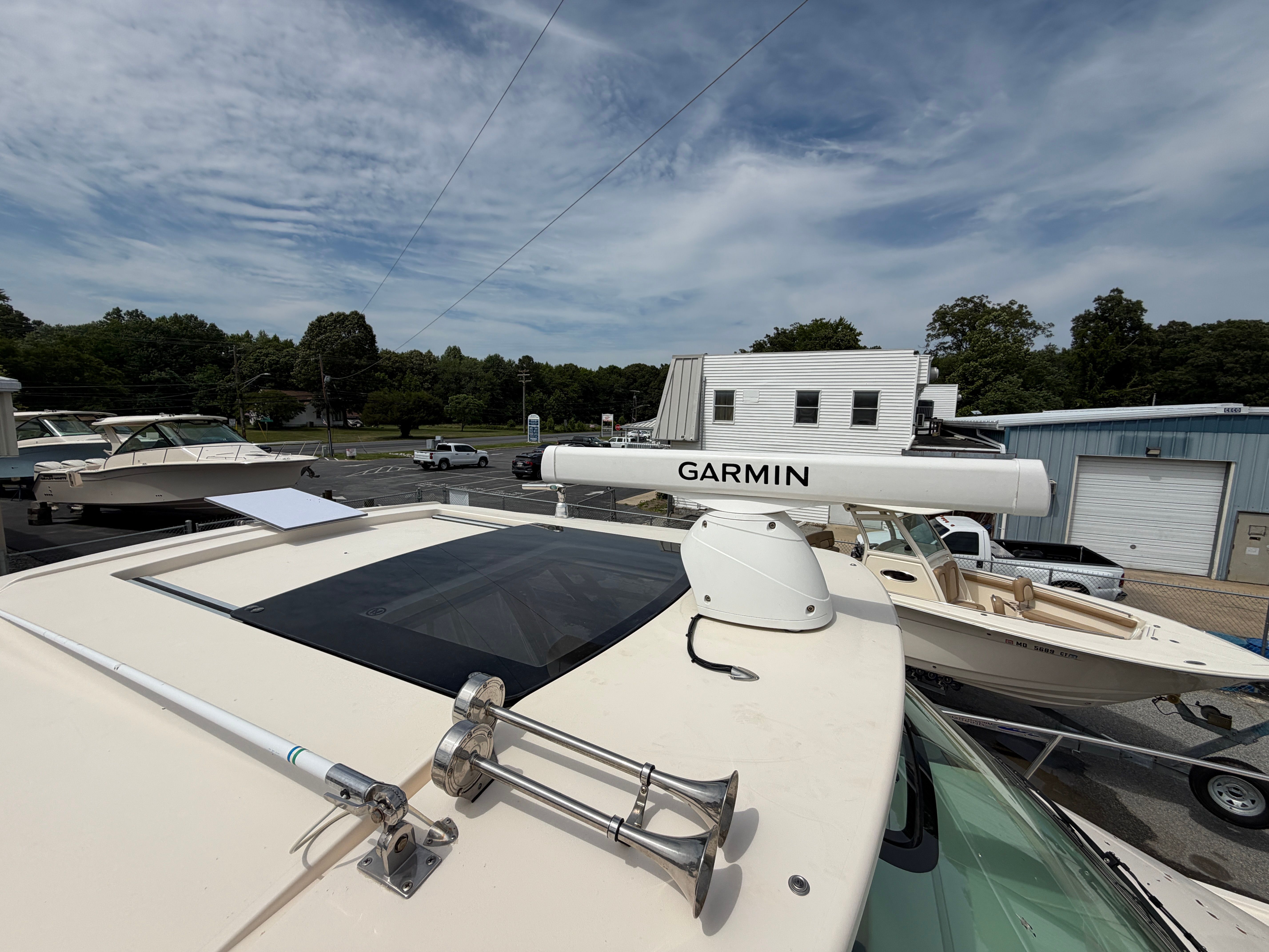 A Grady-White Express 330 boat with Garmin equipment on a parking lot.
