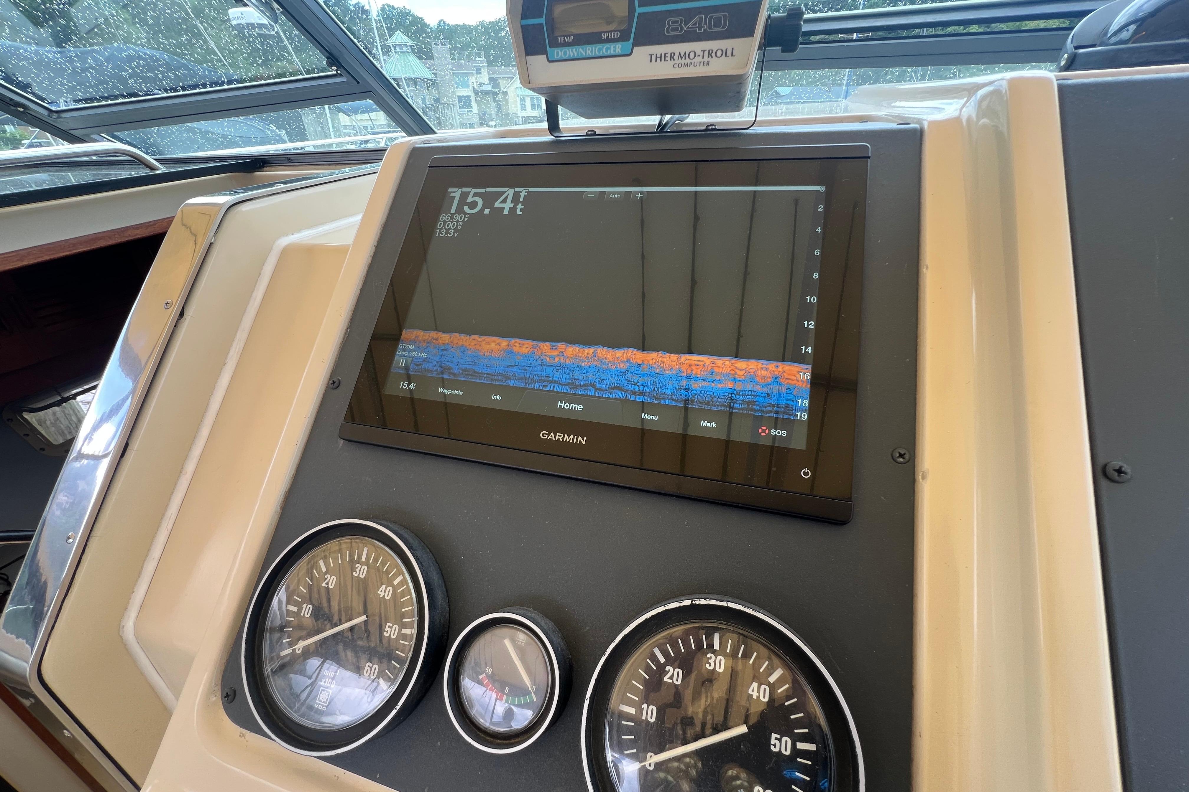 Dashboard of a 1985 Tiara 36 OPEN boat with Garmin display and gauges.