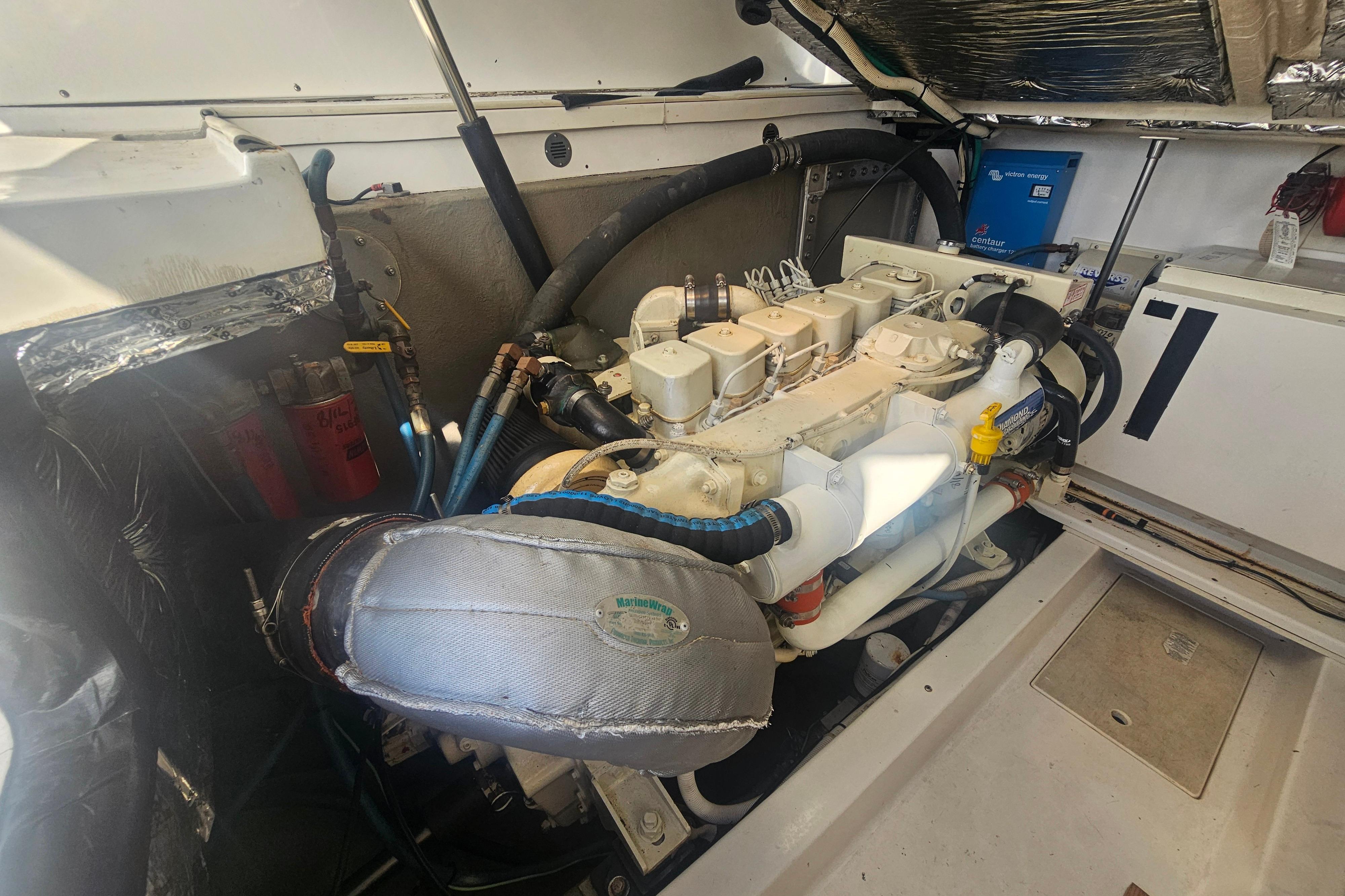 Engine room of 2003 Topaz 32 Express boat, showcasing detailed mechanical components.