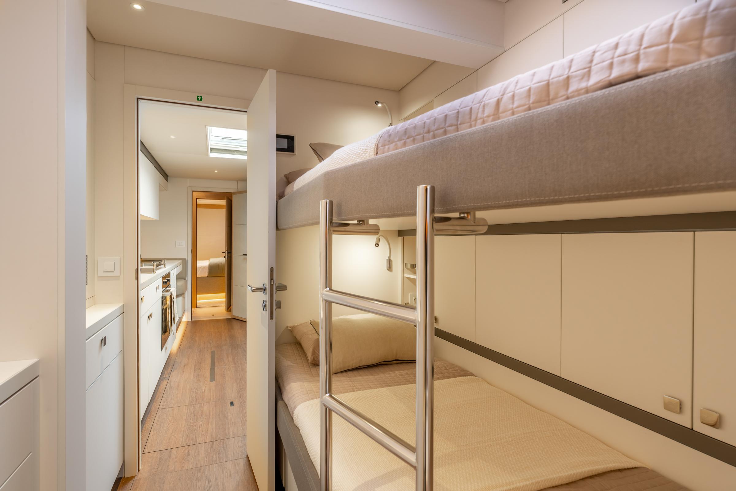 Interior of 2025 Lagoon Eighty 2 yacht with modern bunk beds and sleek design.