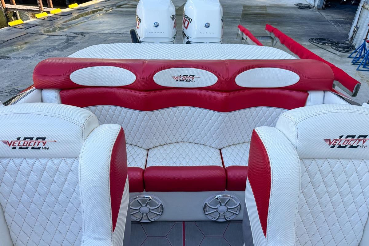 2022 Velocity 290sc boat interior with red and white seating, docked with twin engines.
