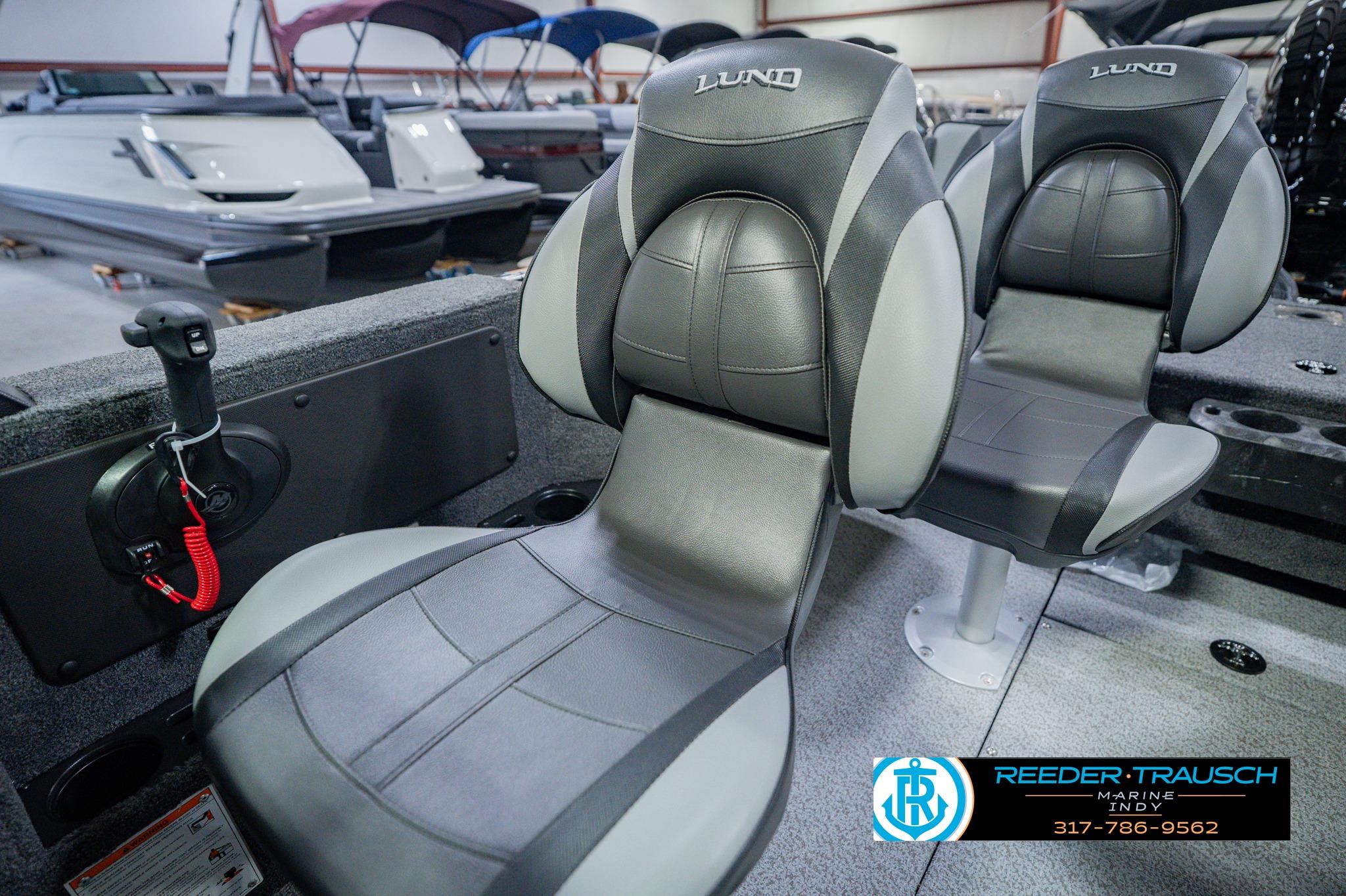 2026 Lund 1775 Impact XS boat seats in showroom, featuring sleek design and comfort.