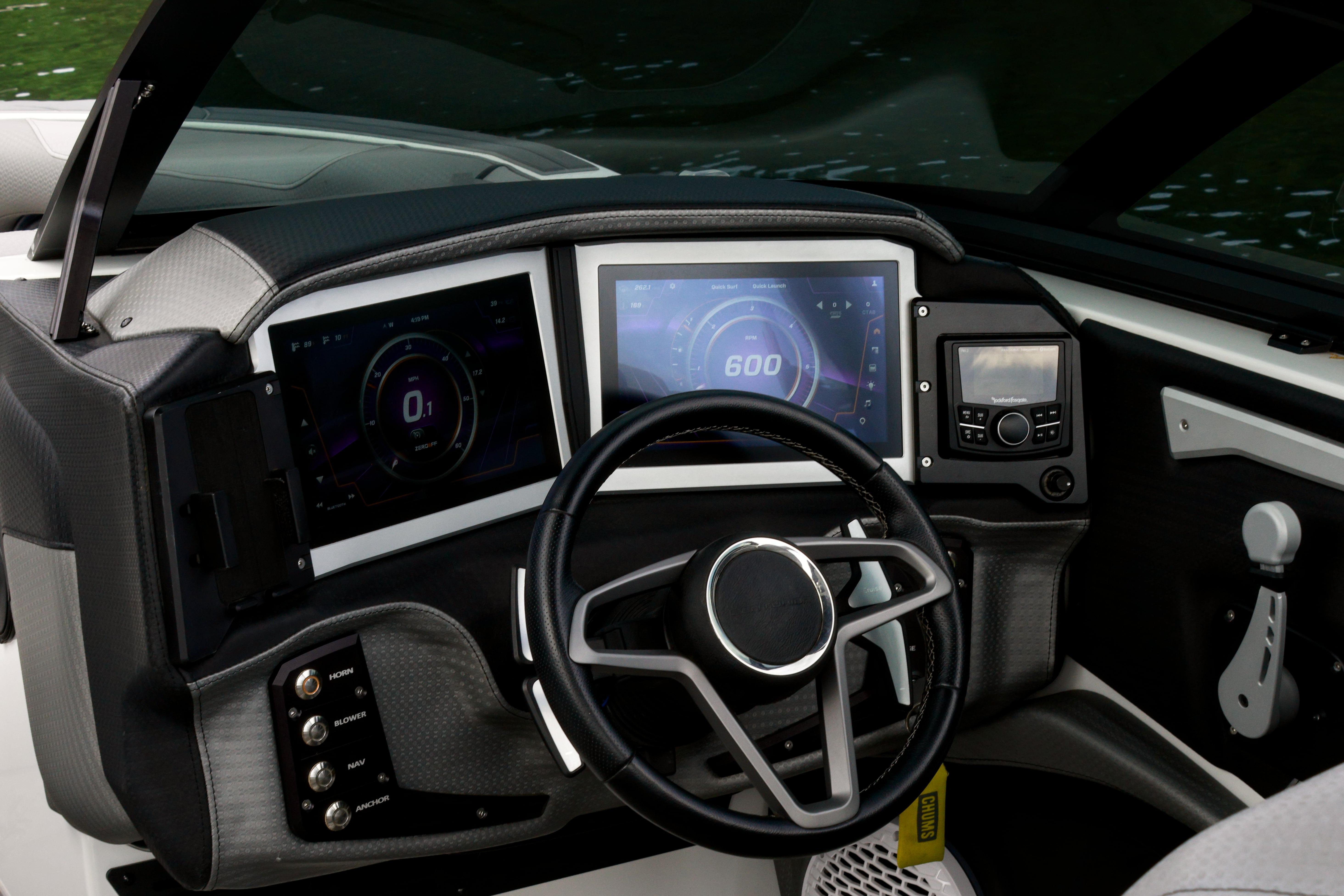 2022 Centurion Ri245 boat dashboard with digital displays and steering wheel.