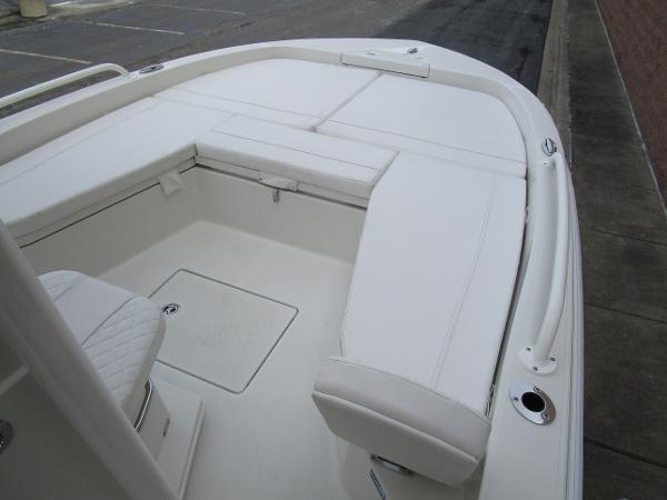 2024 Ranger 2360 Bay boat with white cushioned seating and storage compartments.